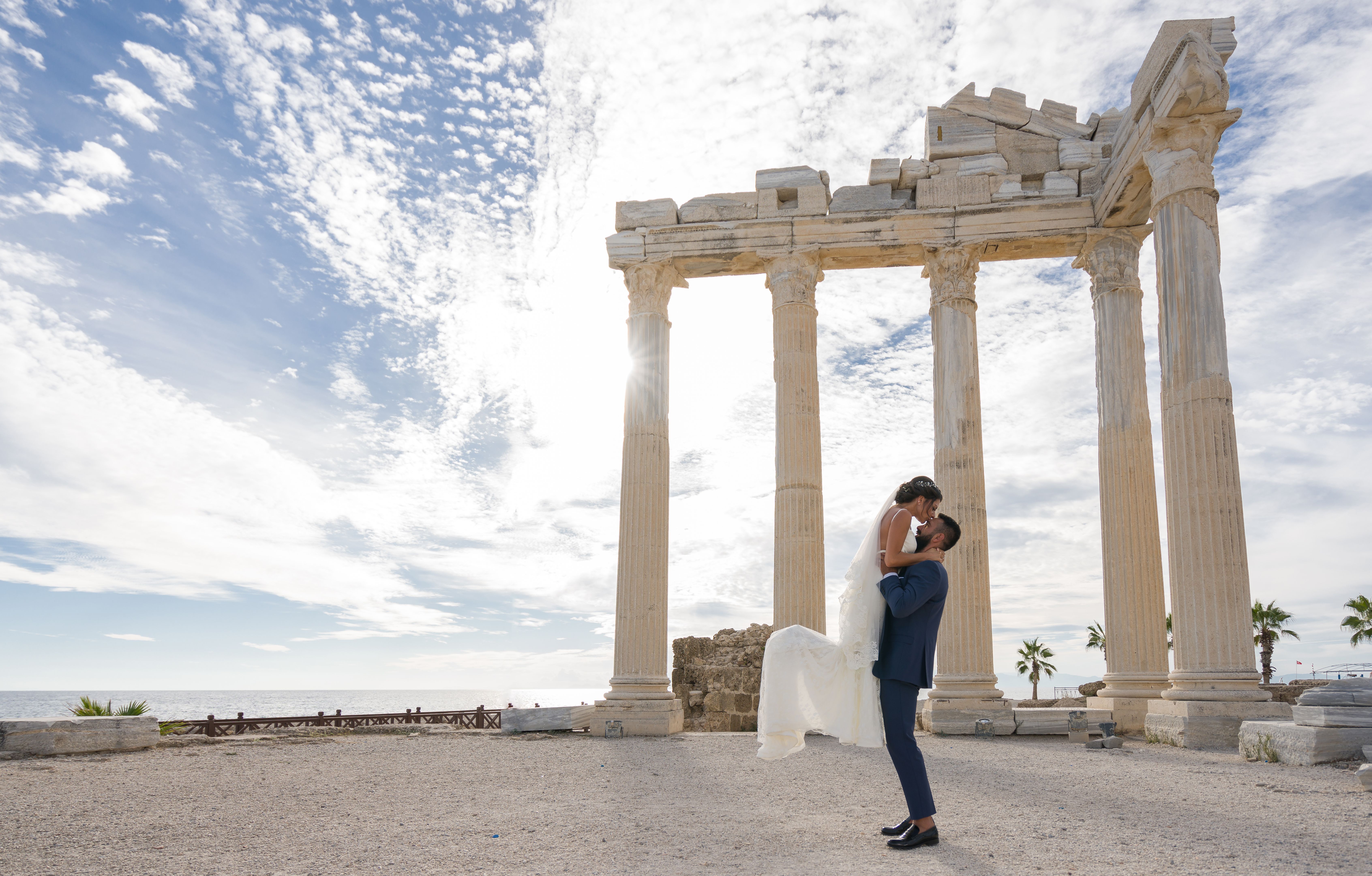 Young married couple in antique city side over temple of Apollo Young married couple in antique city side over temple of Apollo