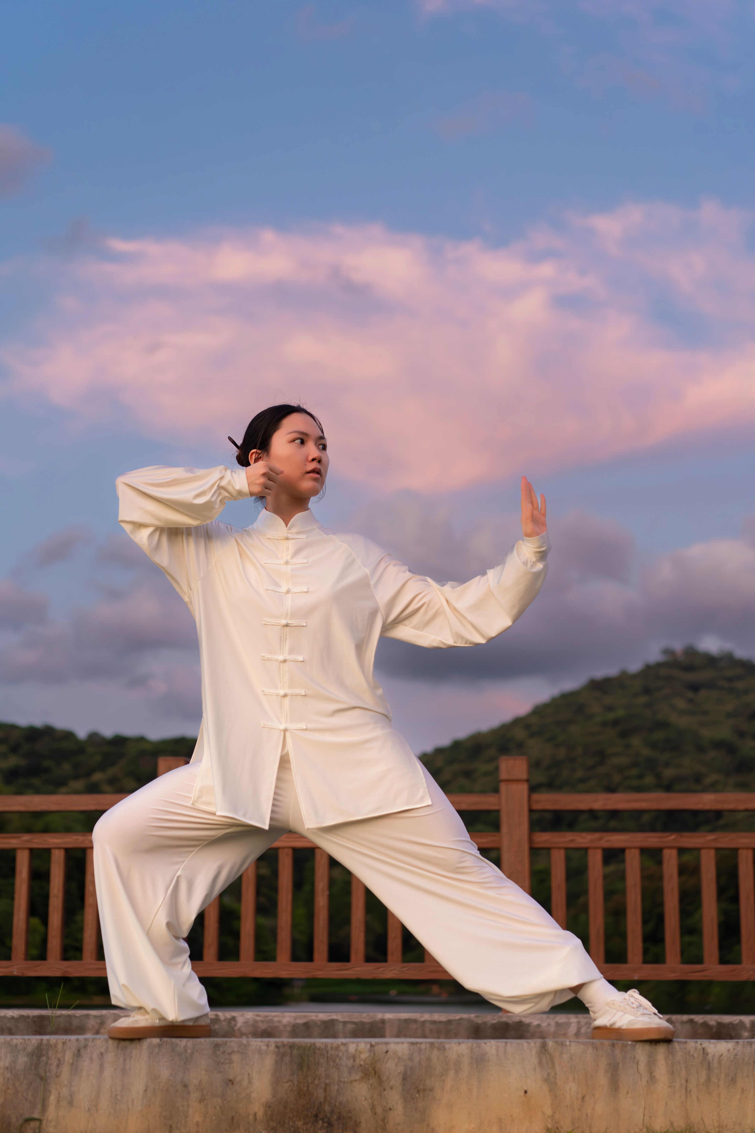 Asian woman is practicing Fitness exercise tai chi in the park.
