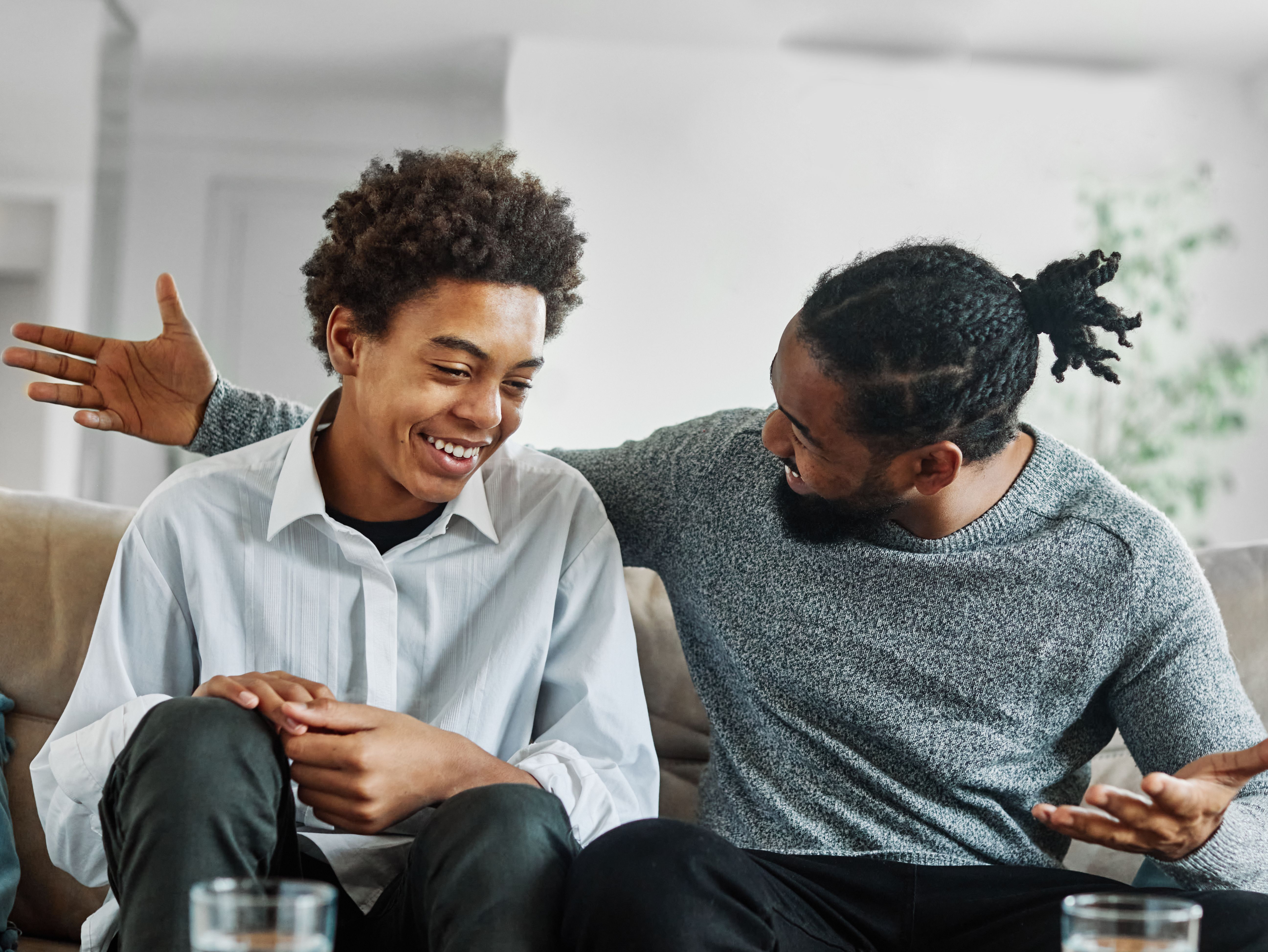 father son family man child conversation talking parent boy happy discussion communication together togetherness bonding care black home talk love dad fun leisure joy