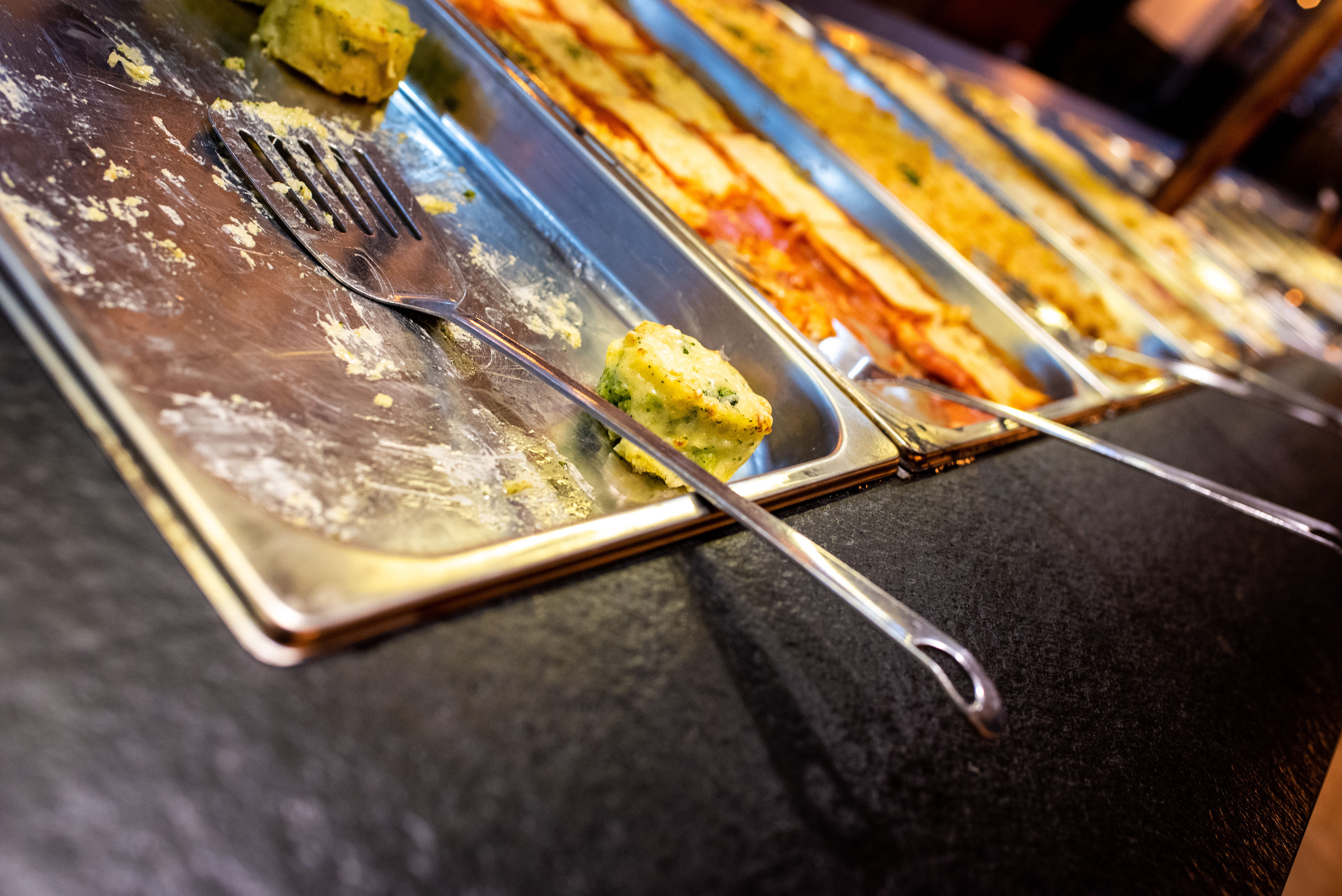Trays with pasta dishes for self-service buffet in a restaurant.