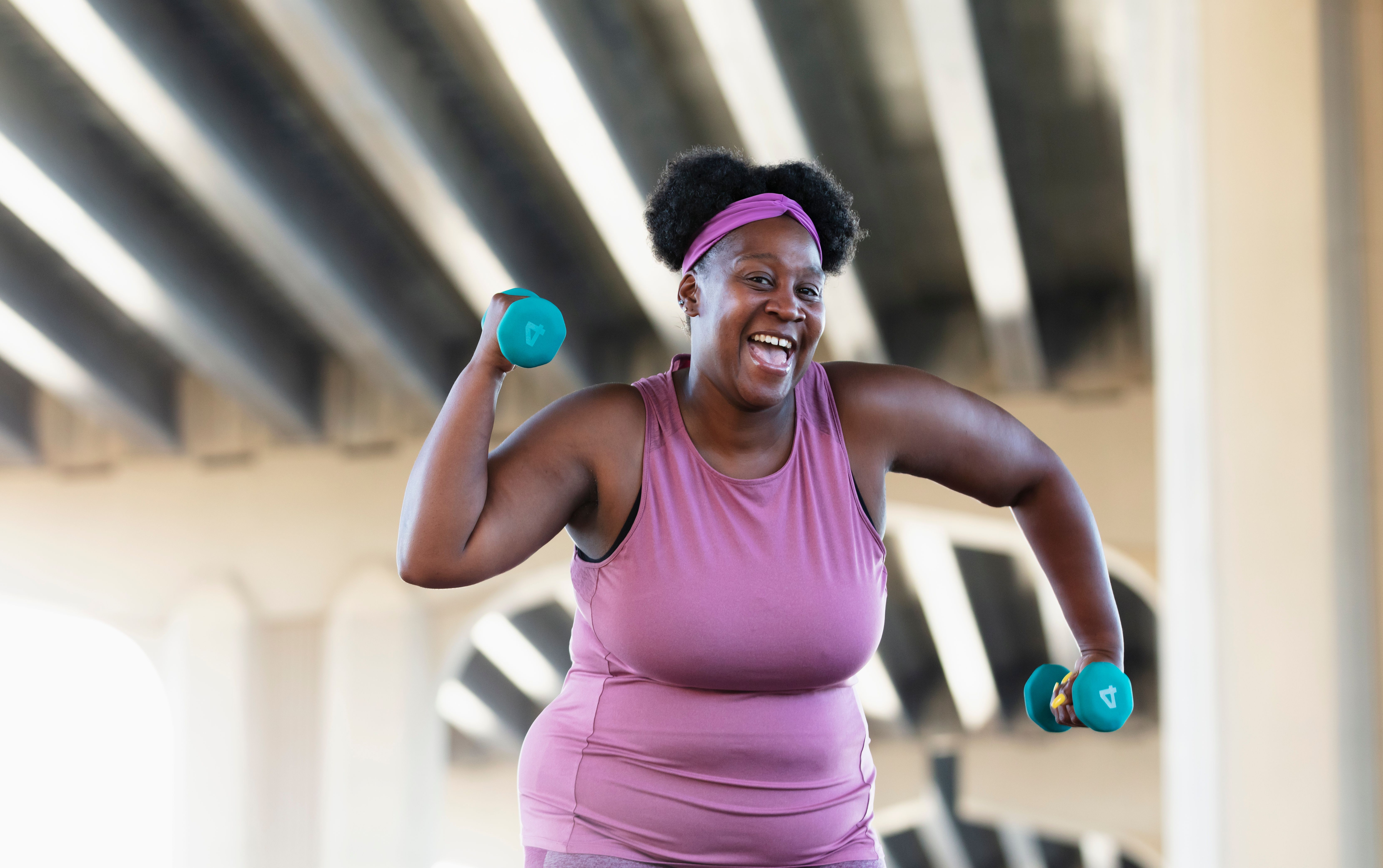 Mature African-American woman flexing muscles