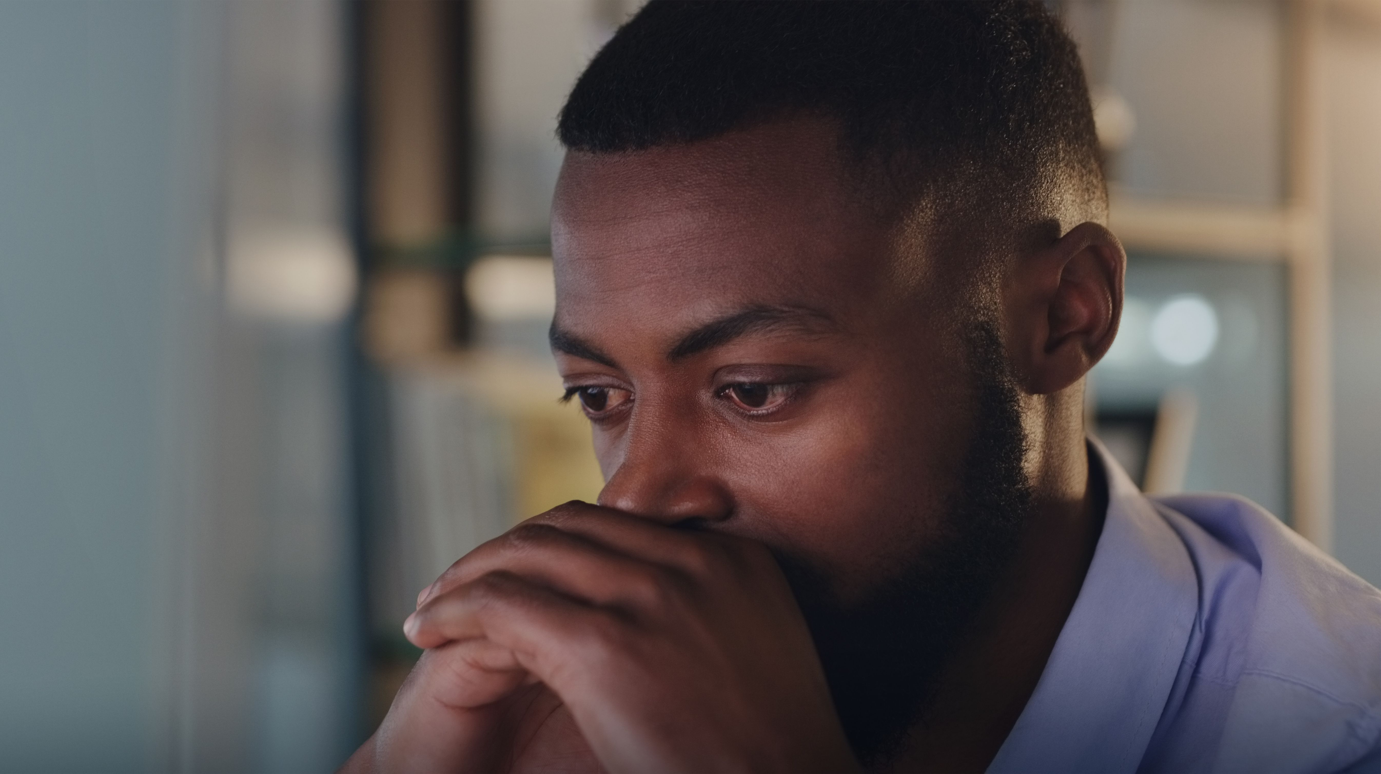 Shot of a young businessman looking stressed out while working in an office