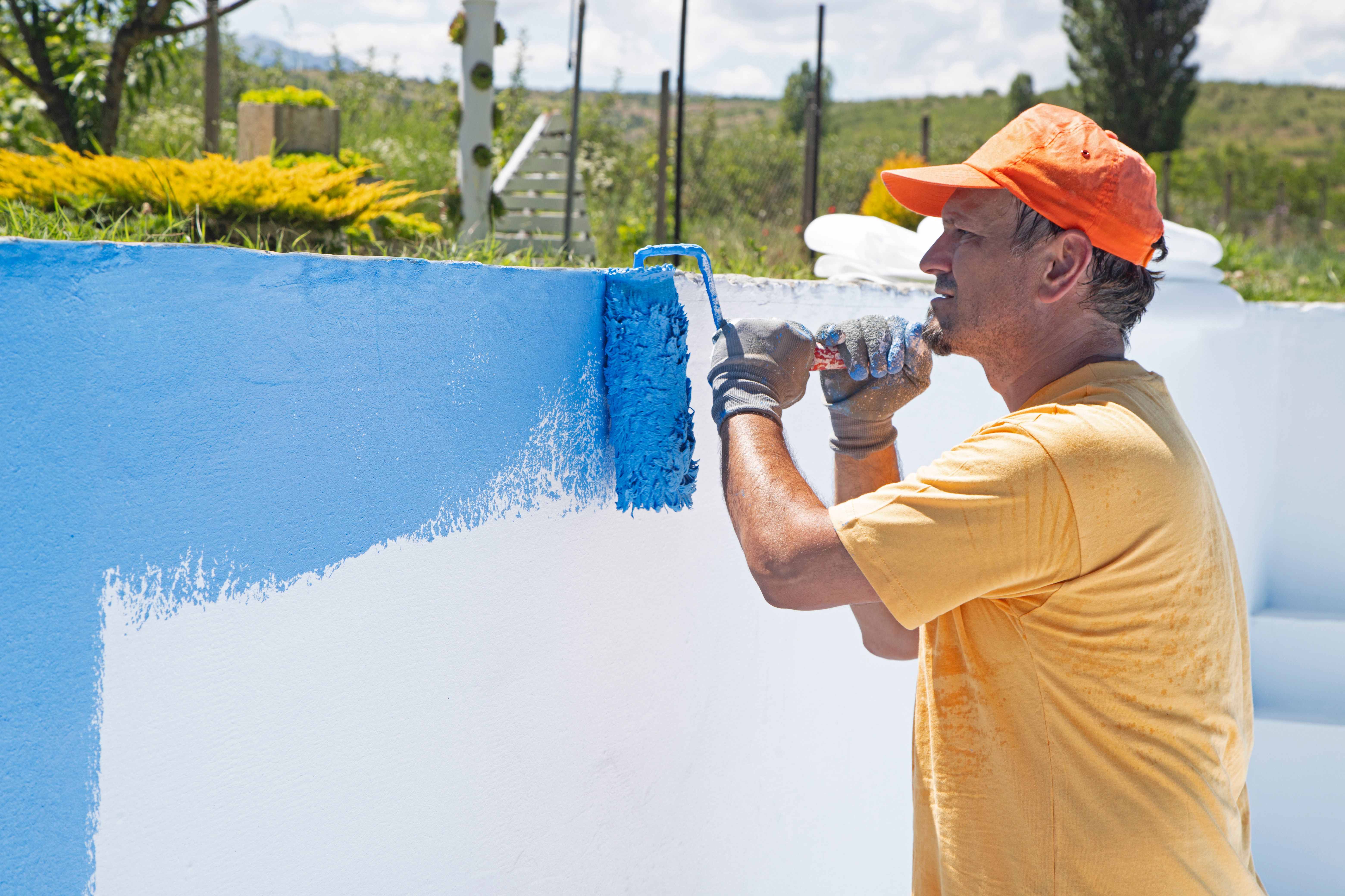 man painting wall