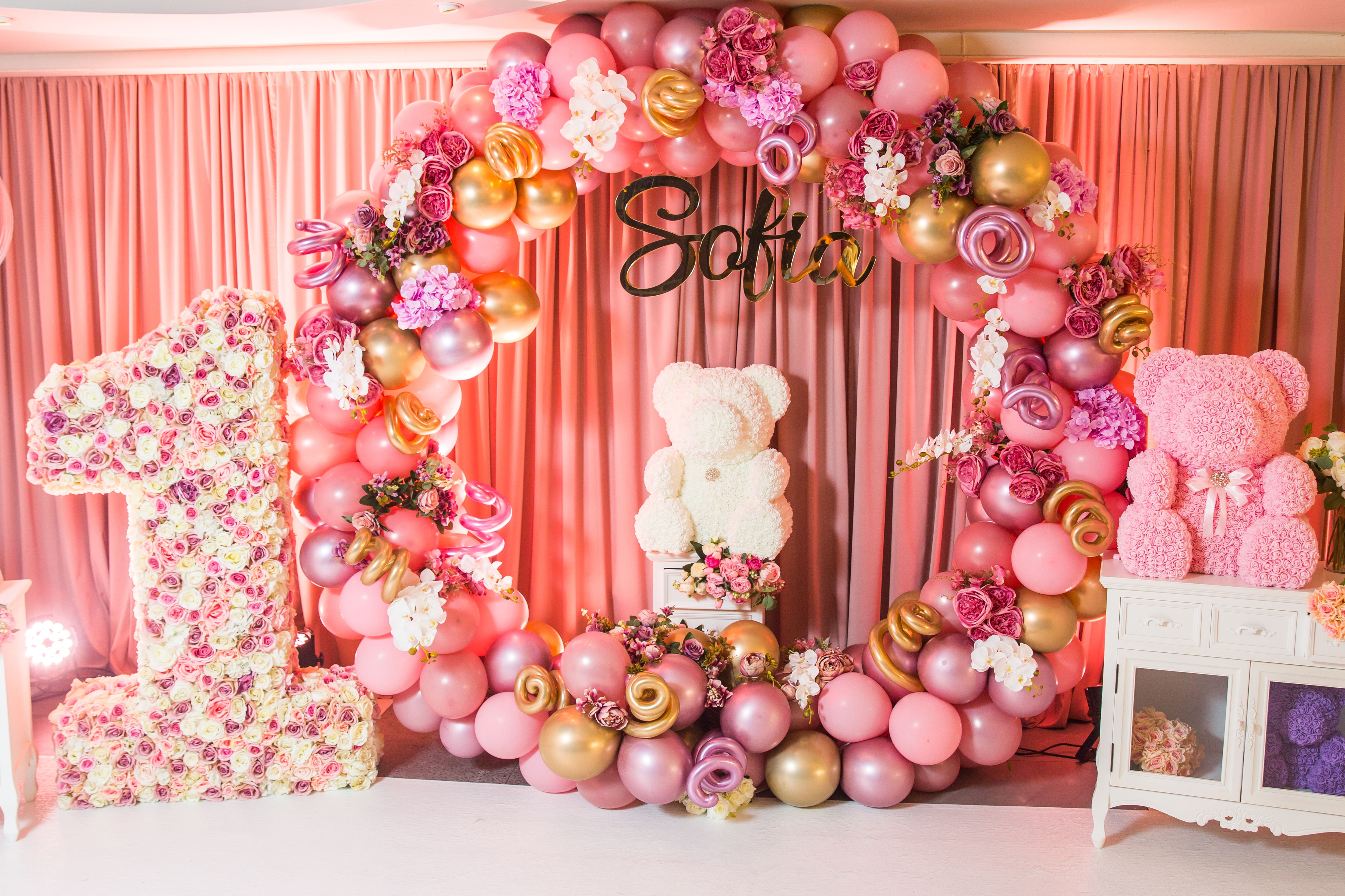 Decoration first birthday. The number 1 in the form of a pinata. Pink 1st birthday pinata on a background