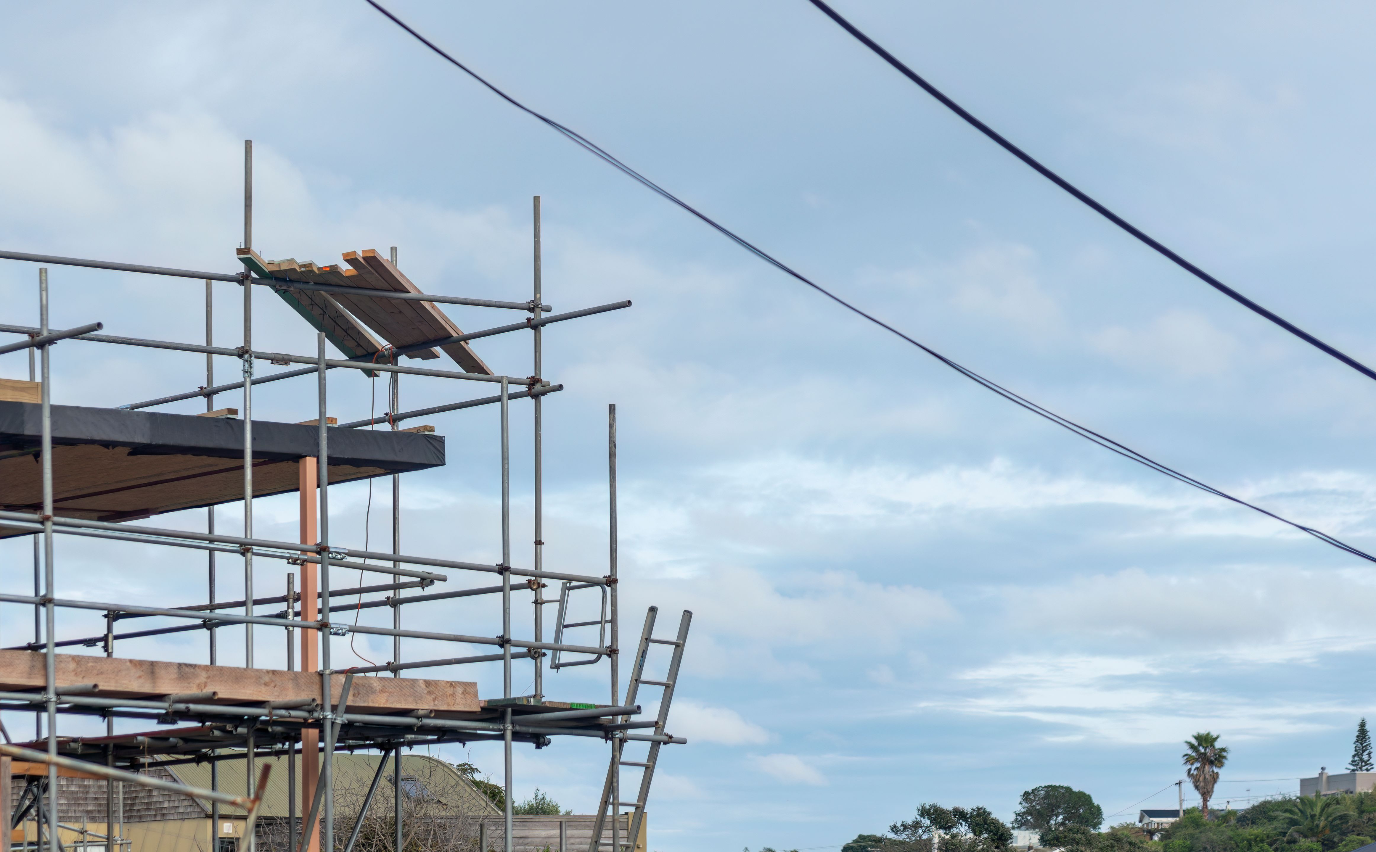 Residential house under construction with metal scaffolding around them. Auckland.