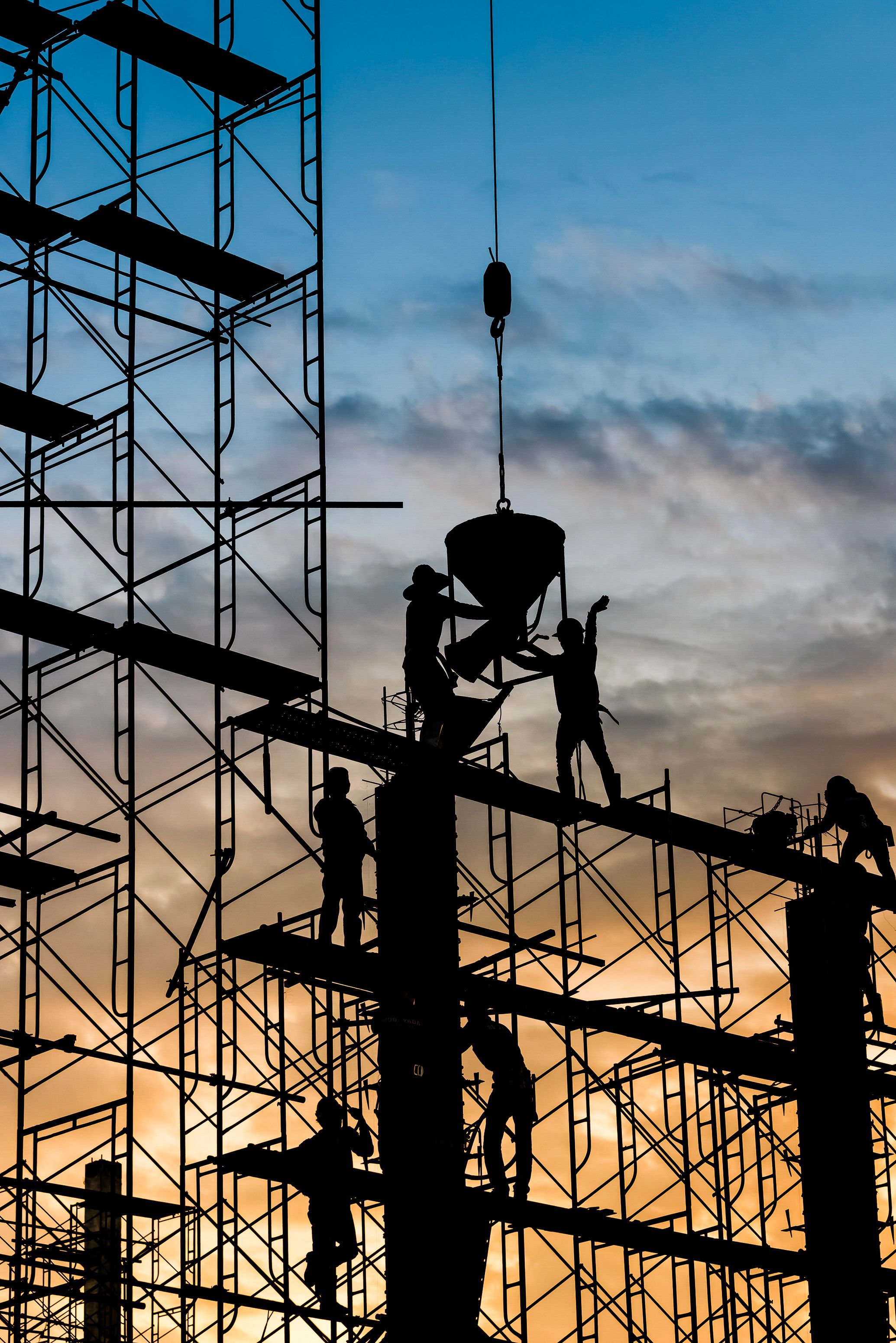 Silhouette of worker. Construction Building casting concrete work on scaffolding