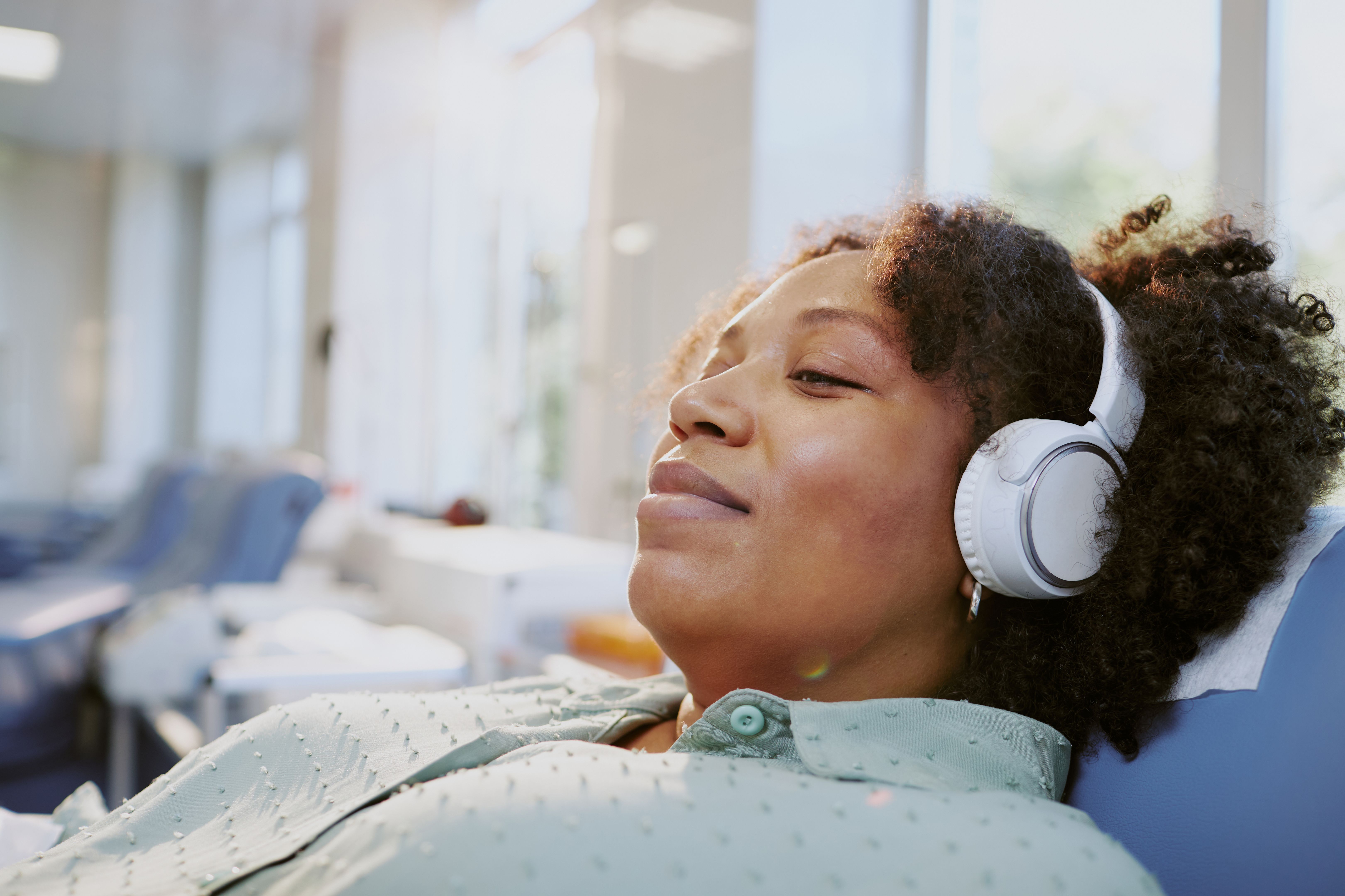 Woman Relaxing with Headphones in Living Room Woman Relaxing with Headphones in Living Room
