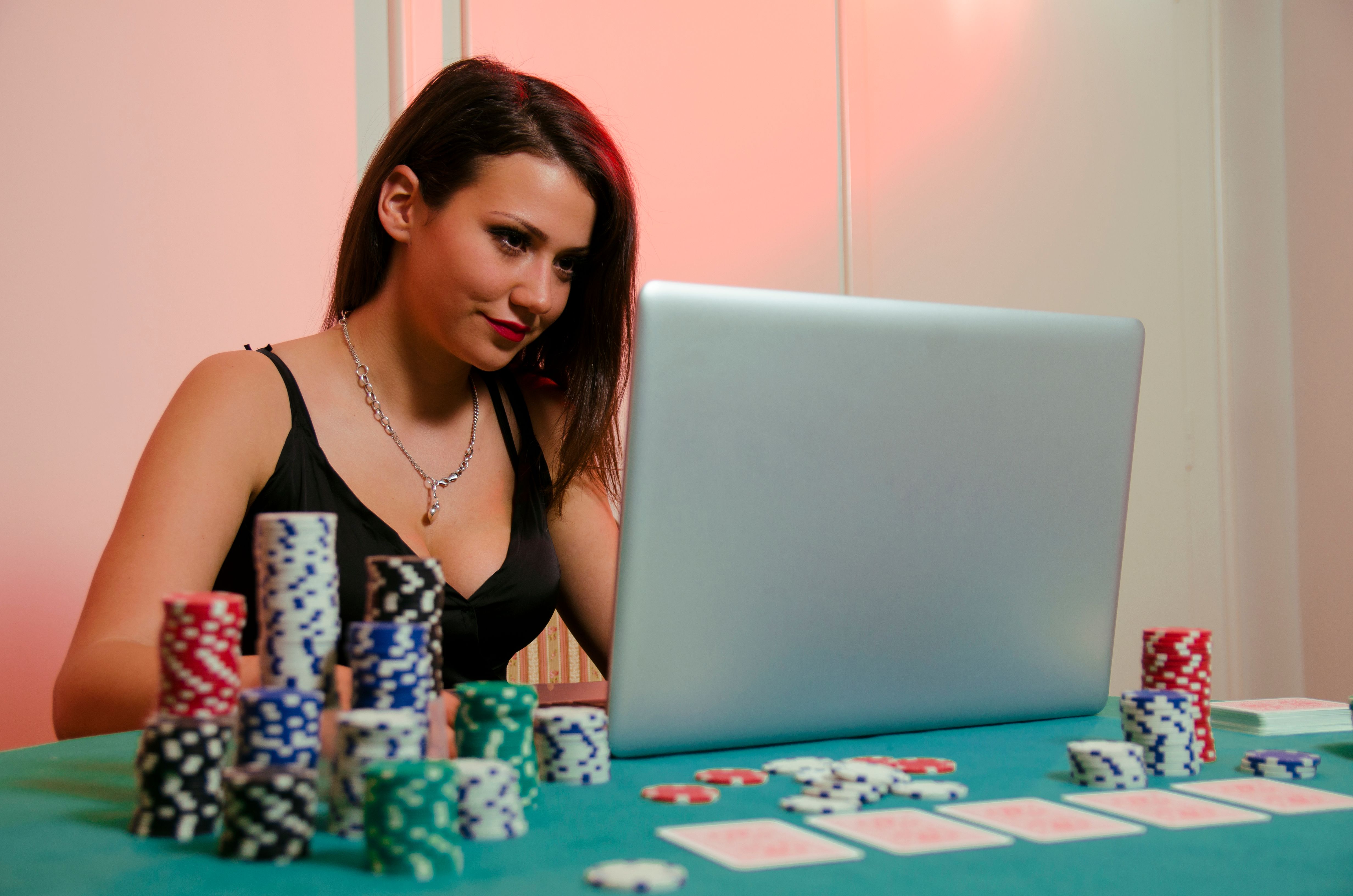 Beautiful young woman in attractive black dress playing poker online Beautiful young woman in attractive black dress playing poker online