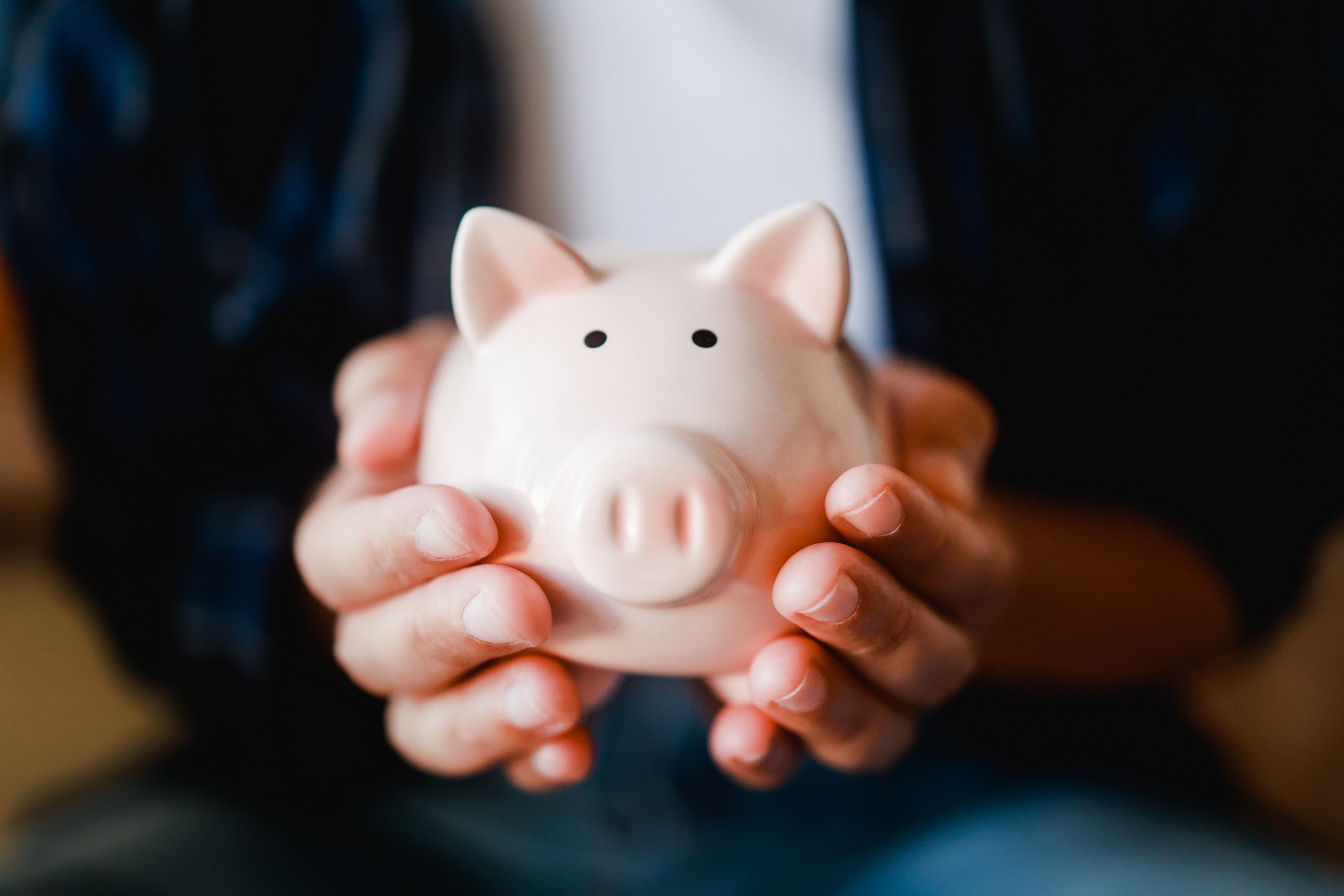 Hands holding piggy for saving money. Invest and finacial bank concept Hands holding piggy for saving money. Invest and finacial bank concept