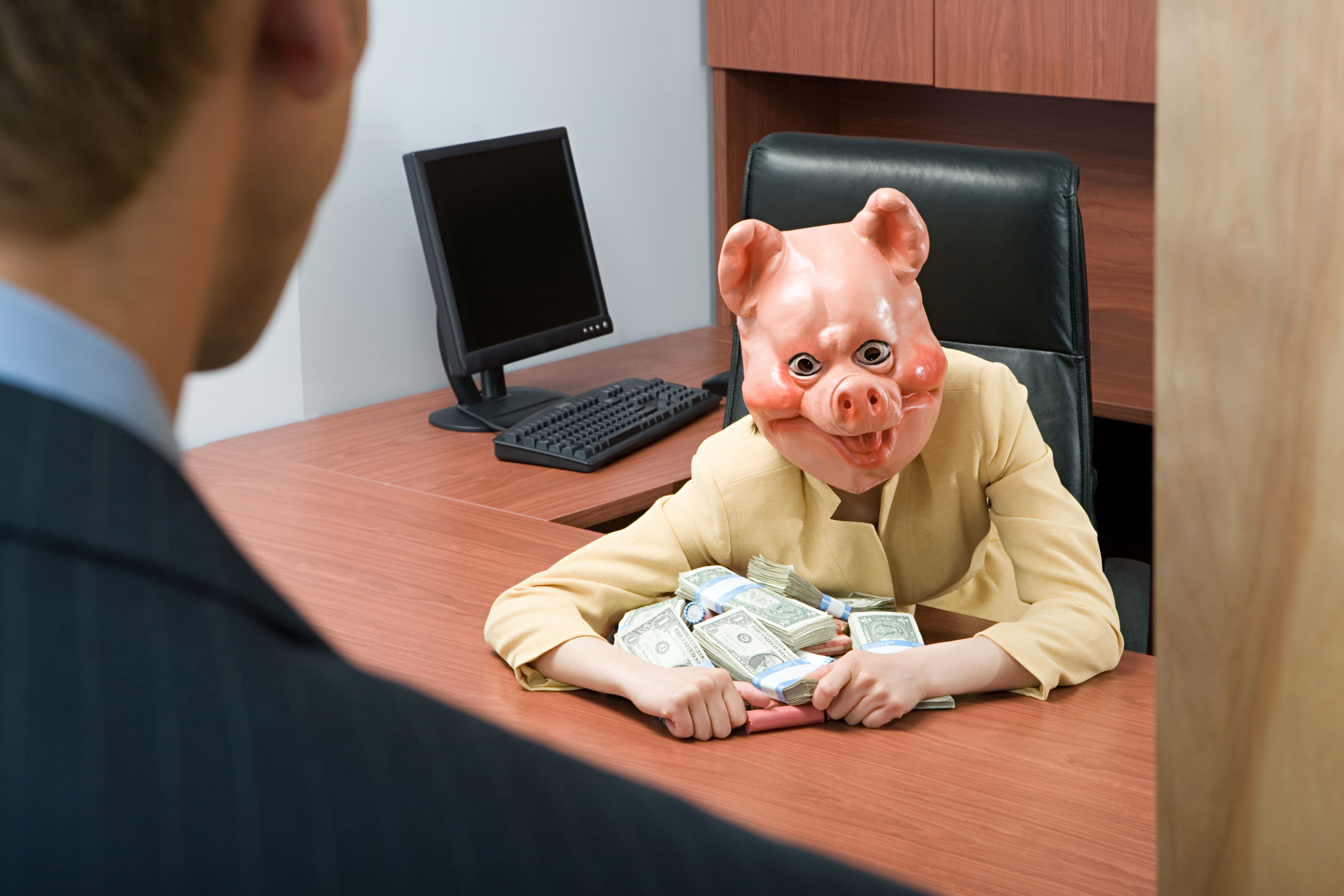 Businesswoman in pig mask holding money Businesswoman in pig mask holding money