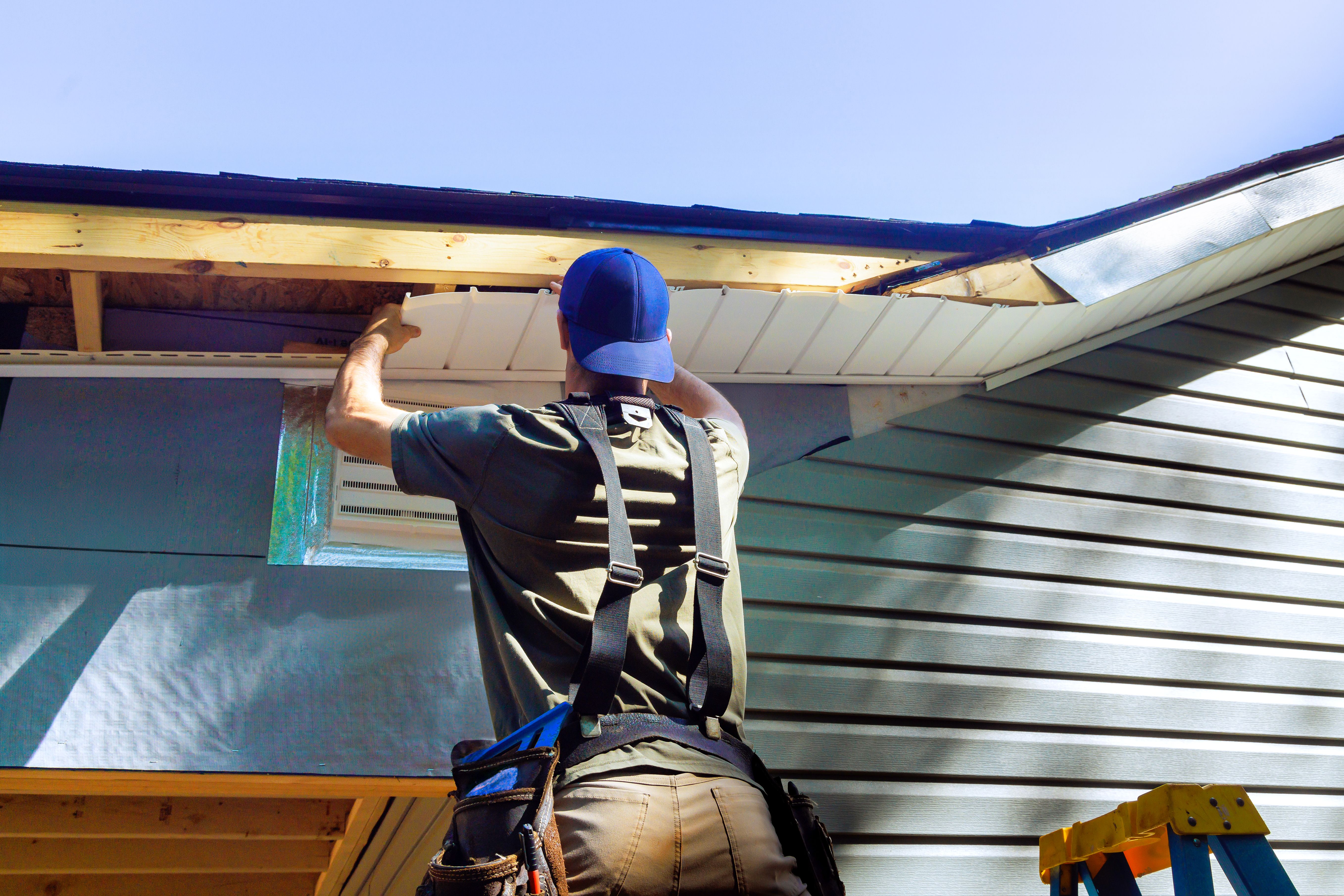 Plastic soffits mounted to roof rafters on house with a cathedral ceiling