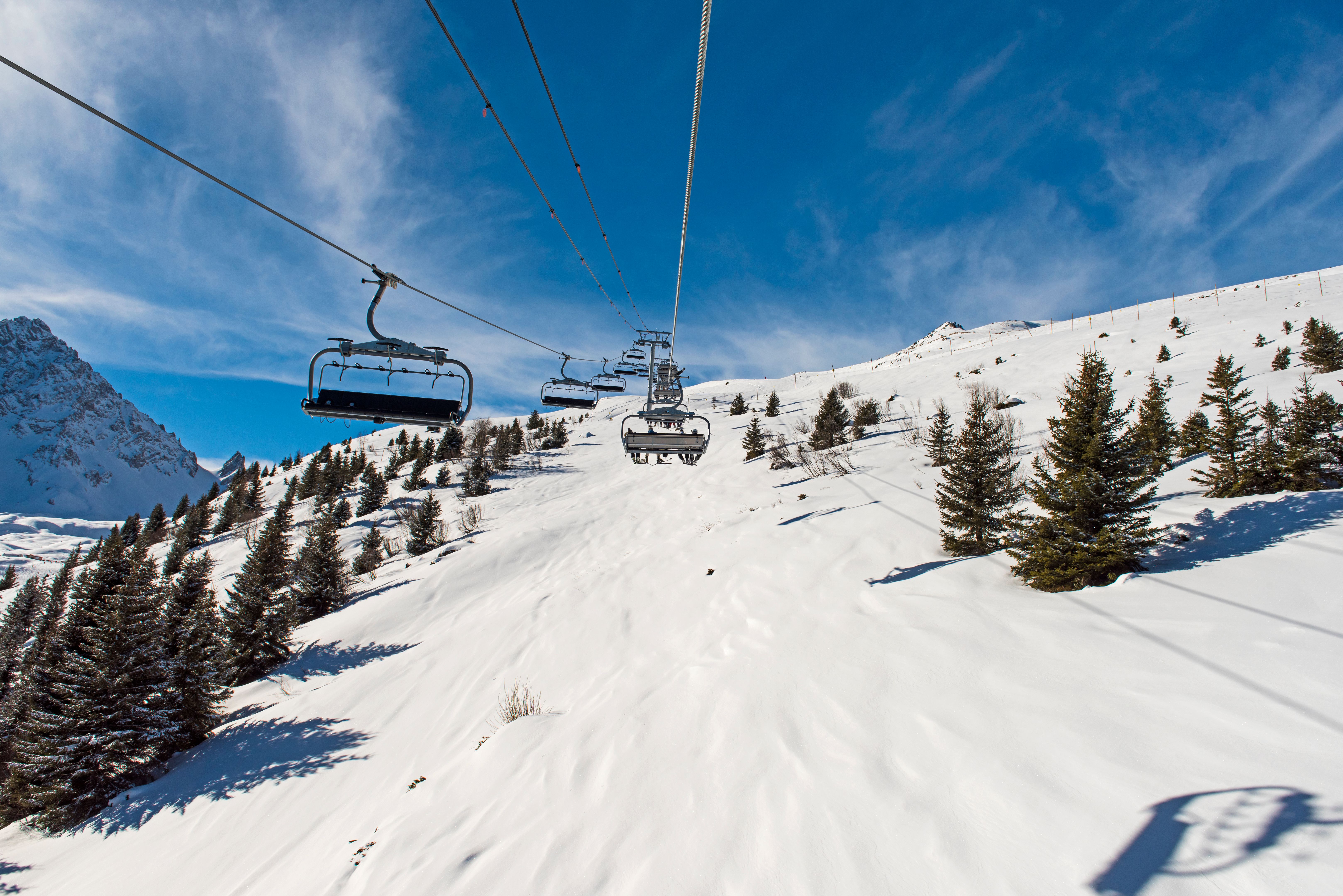 Panoramic view of an alpine mountainside with ski lift