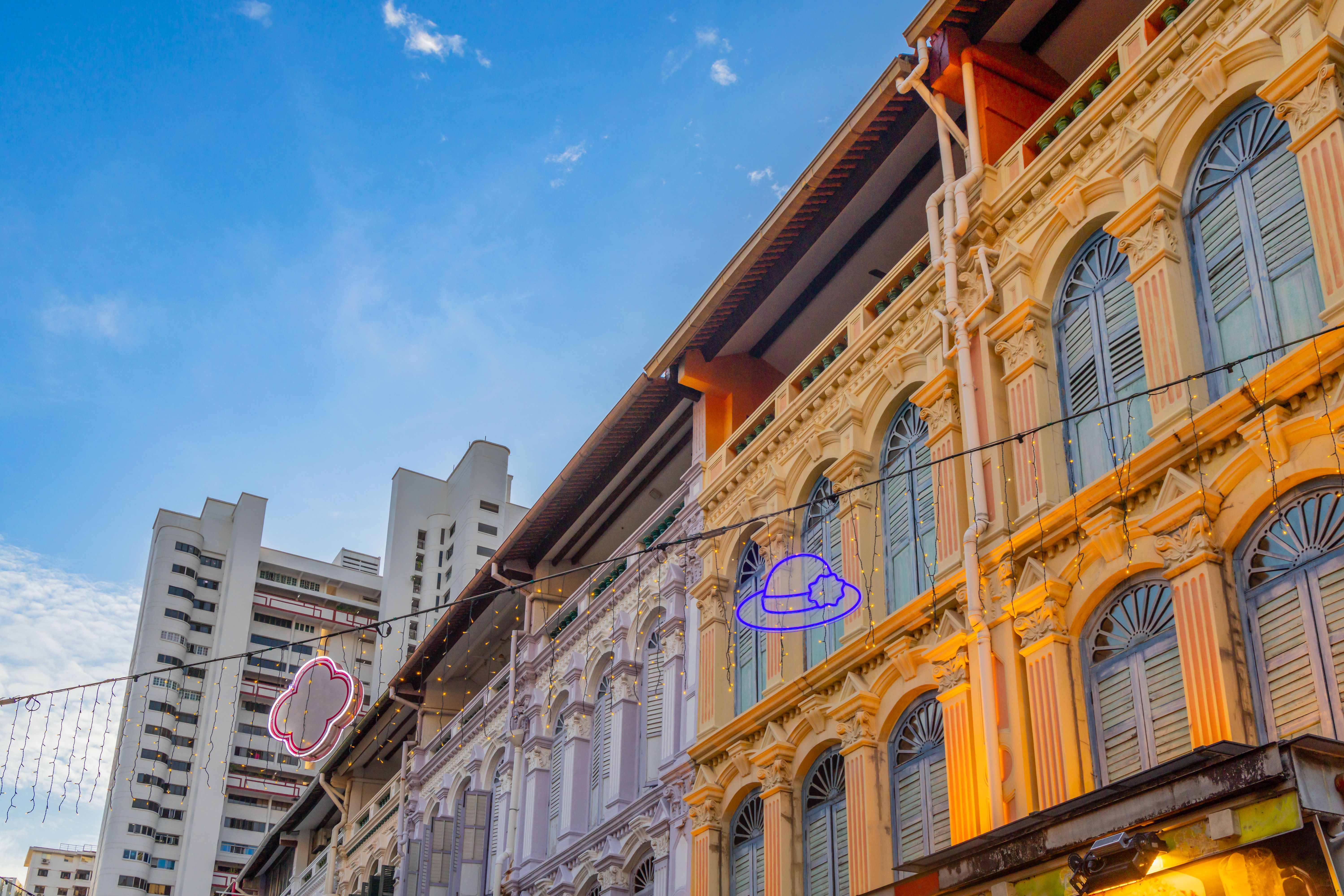 Colorful old colonial style houses with modern building in the background, China town, Singapore