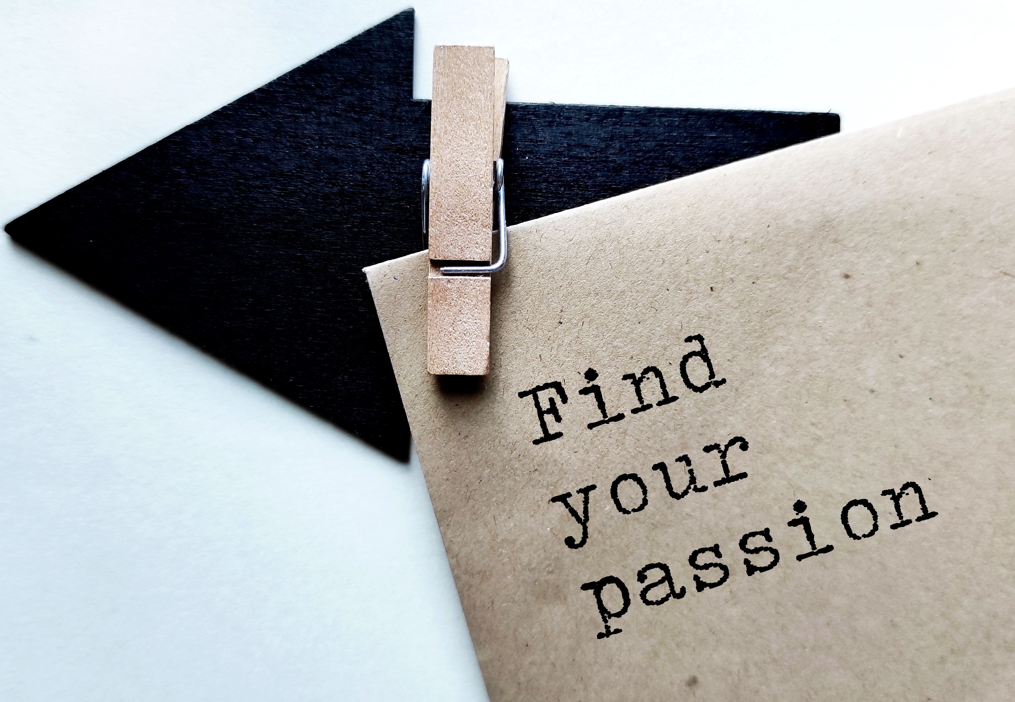 Black direction arrow with craft envelope and typed text FIND YOUR PASSION, means finding something youre passionate about and do it for a living Black direction arrow with craft envelope and typed text FIND YOUR PASSION, means finding something youre passionate about and do it for a living