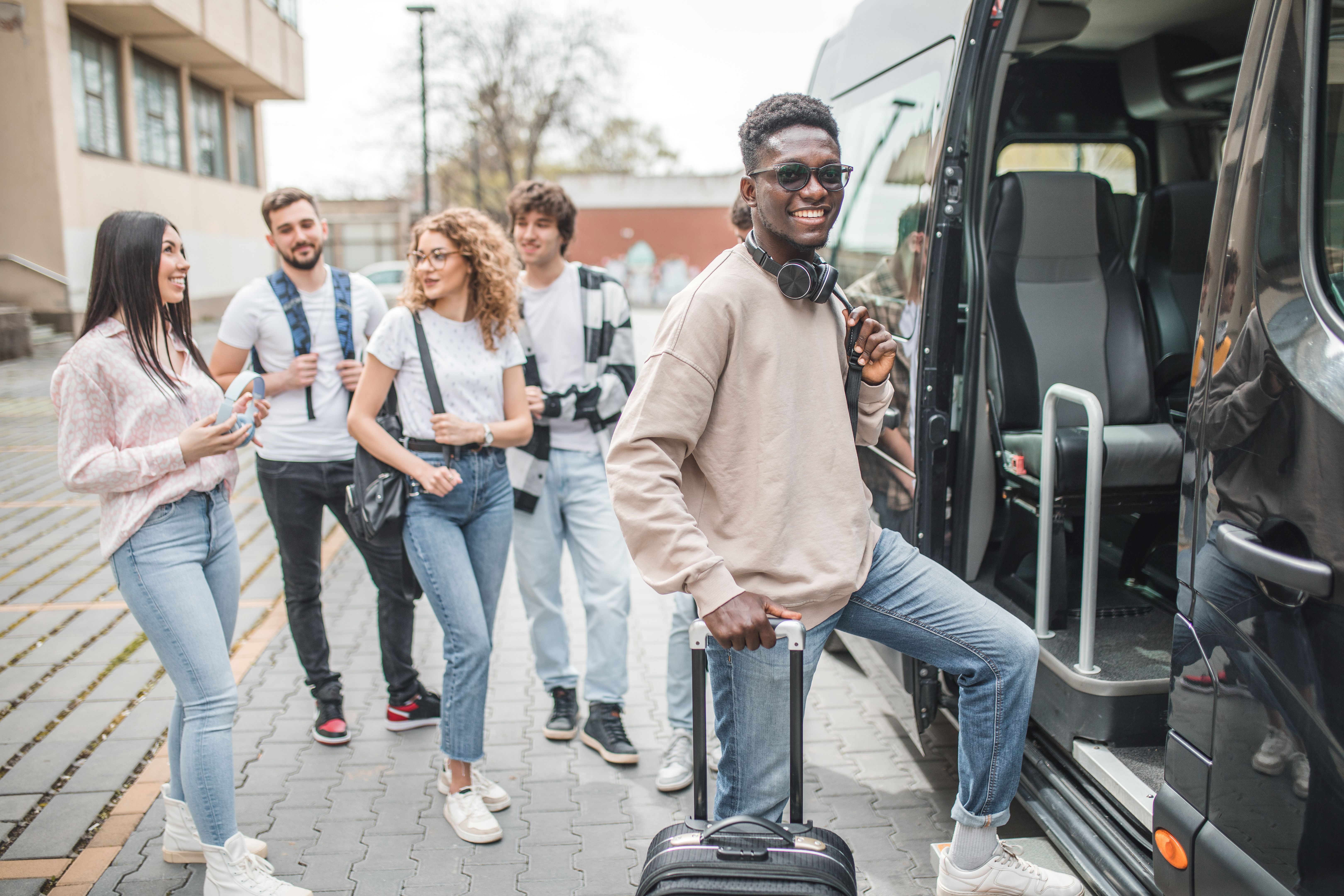 Portrait of a smiling black man boarding a minibus