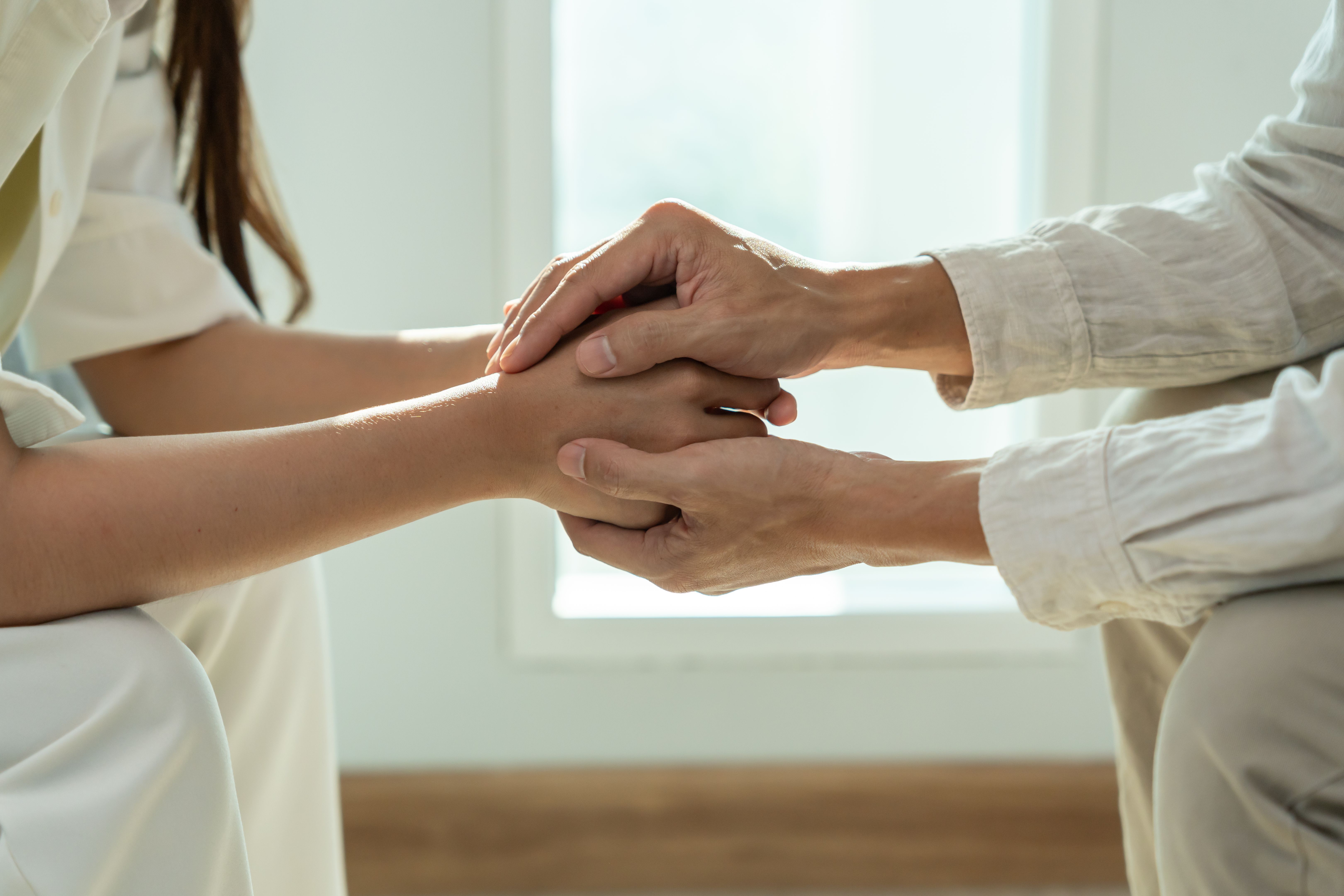 psychiatrist hold hand support each while discussing family issues. doctor encourages and empathy man suffers depression. psychological, save divorce, Hand in hand together, trust, care psychiatrist hold hand support each while discussing family issues. doctor encourages and empathy man suffers depression. psychological, save divorce, Hand in hand together, trust, care