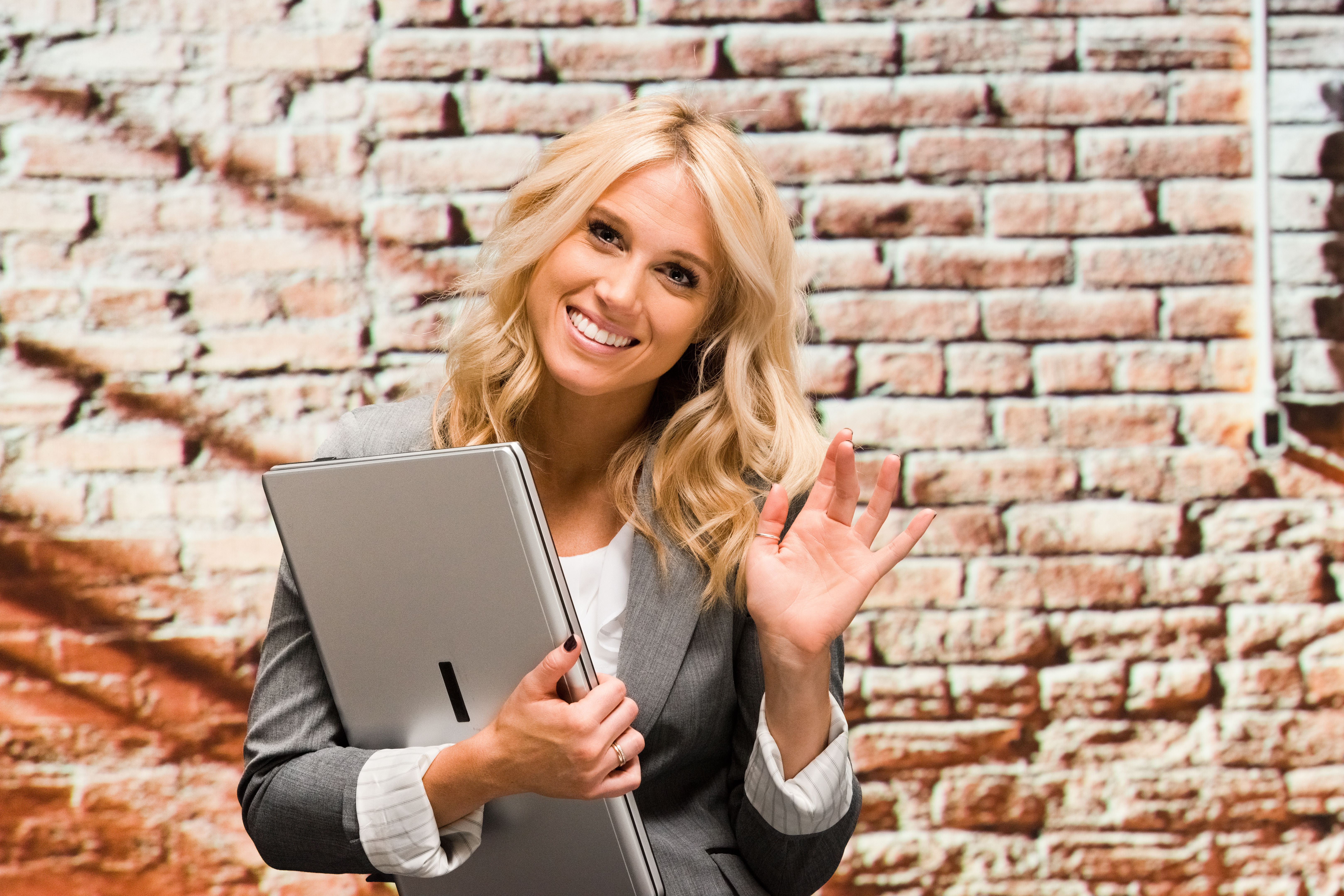 Smiling businesswoman waving hand