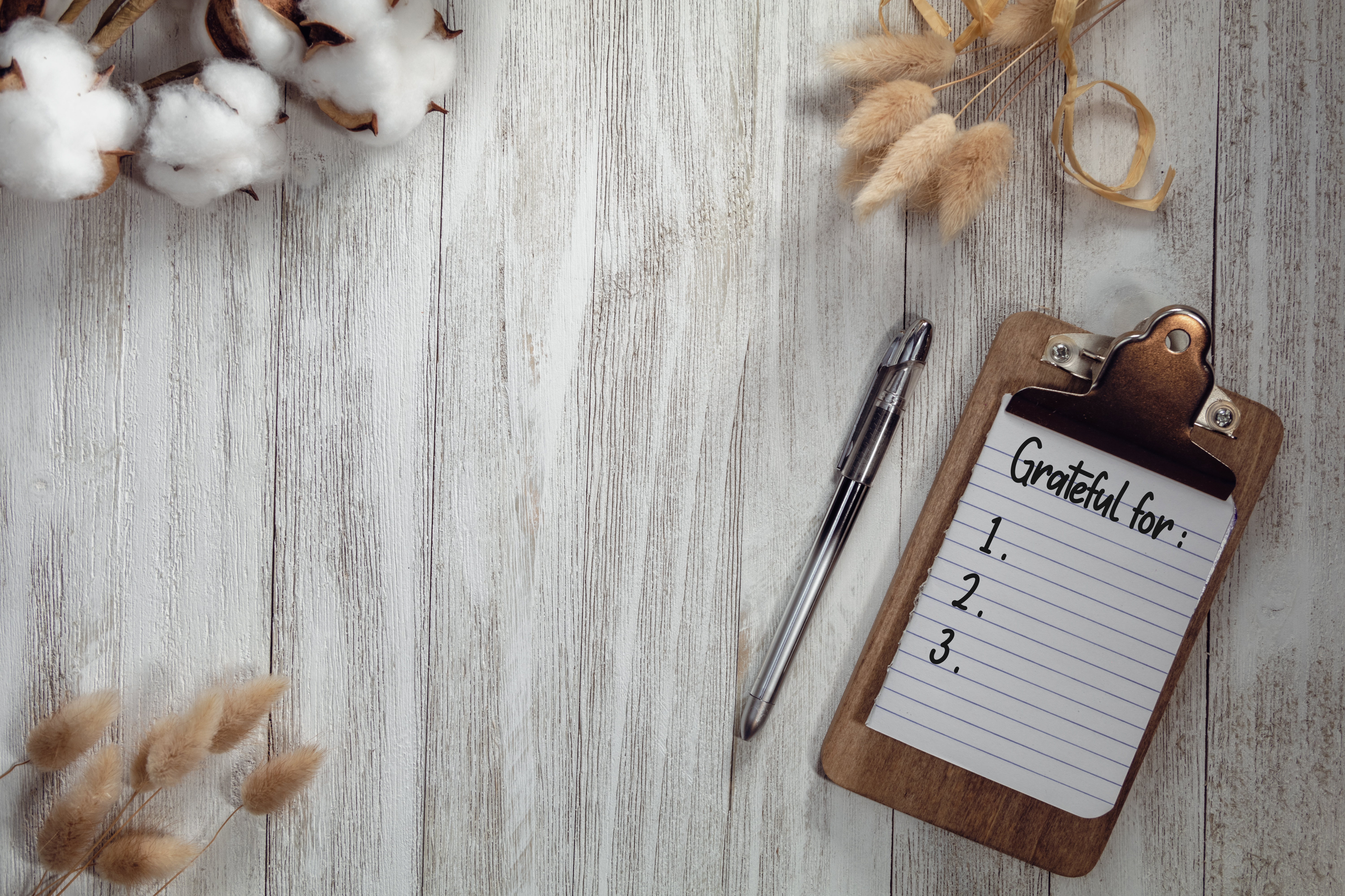 Grateful for text list on notepad with rustic wooden gray flat lay background and natural elements