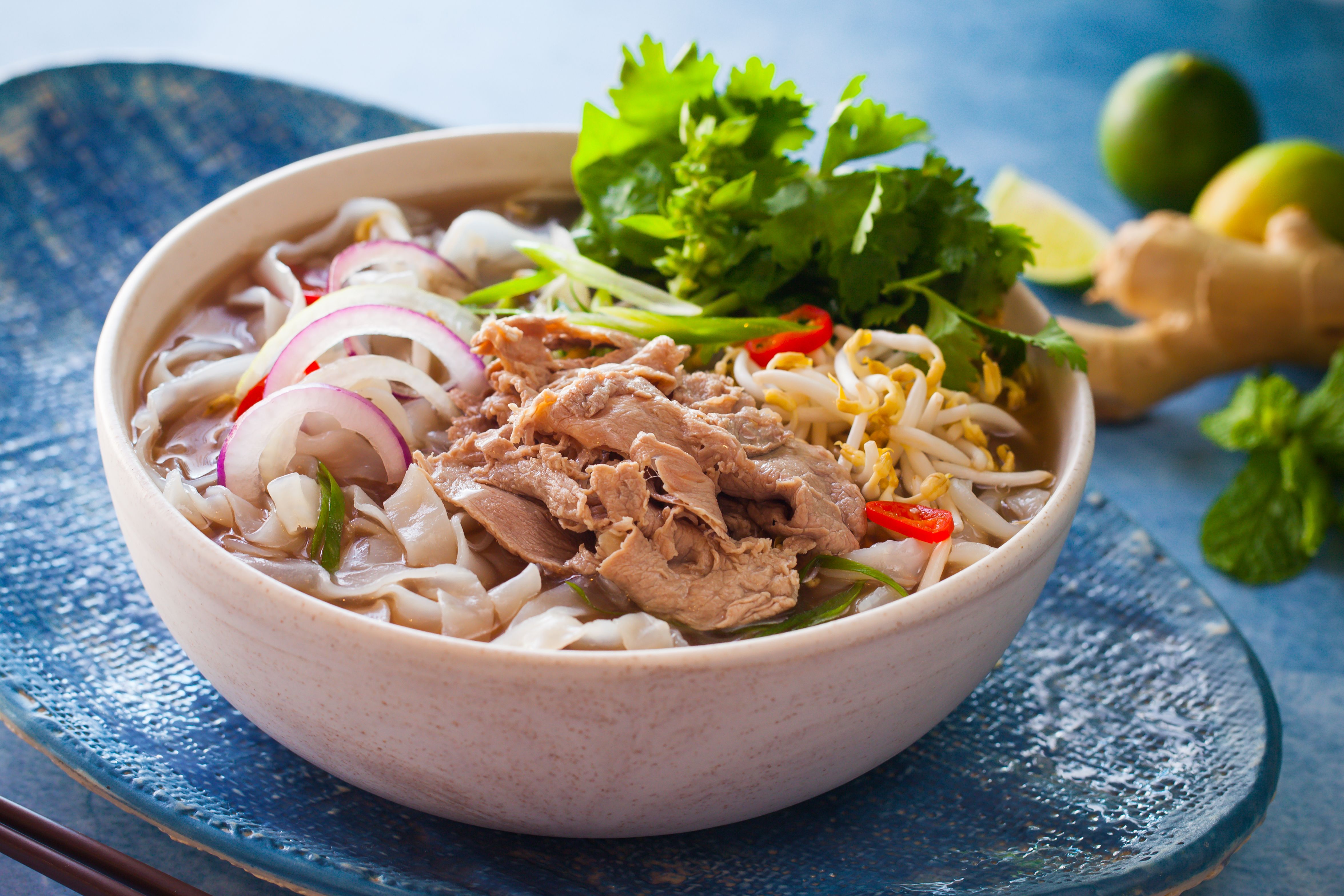 Traditional beef pho with herbs and lime in Vietnam