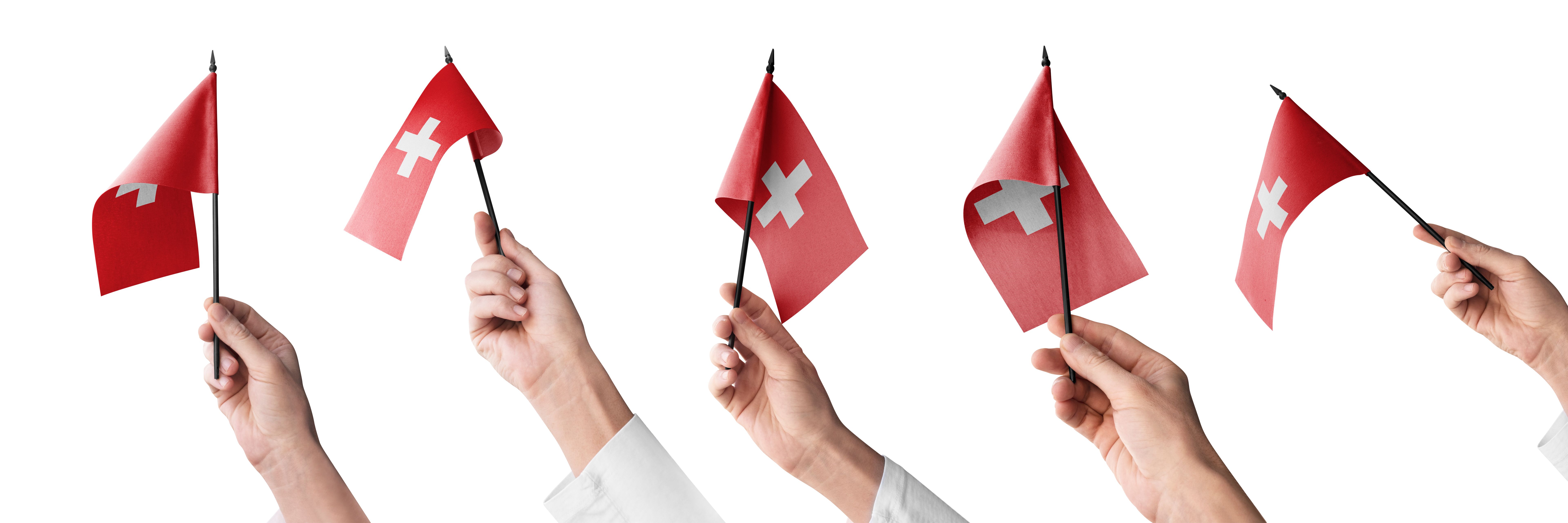 The Switzerland flag in hand in different angles on a white background