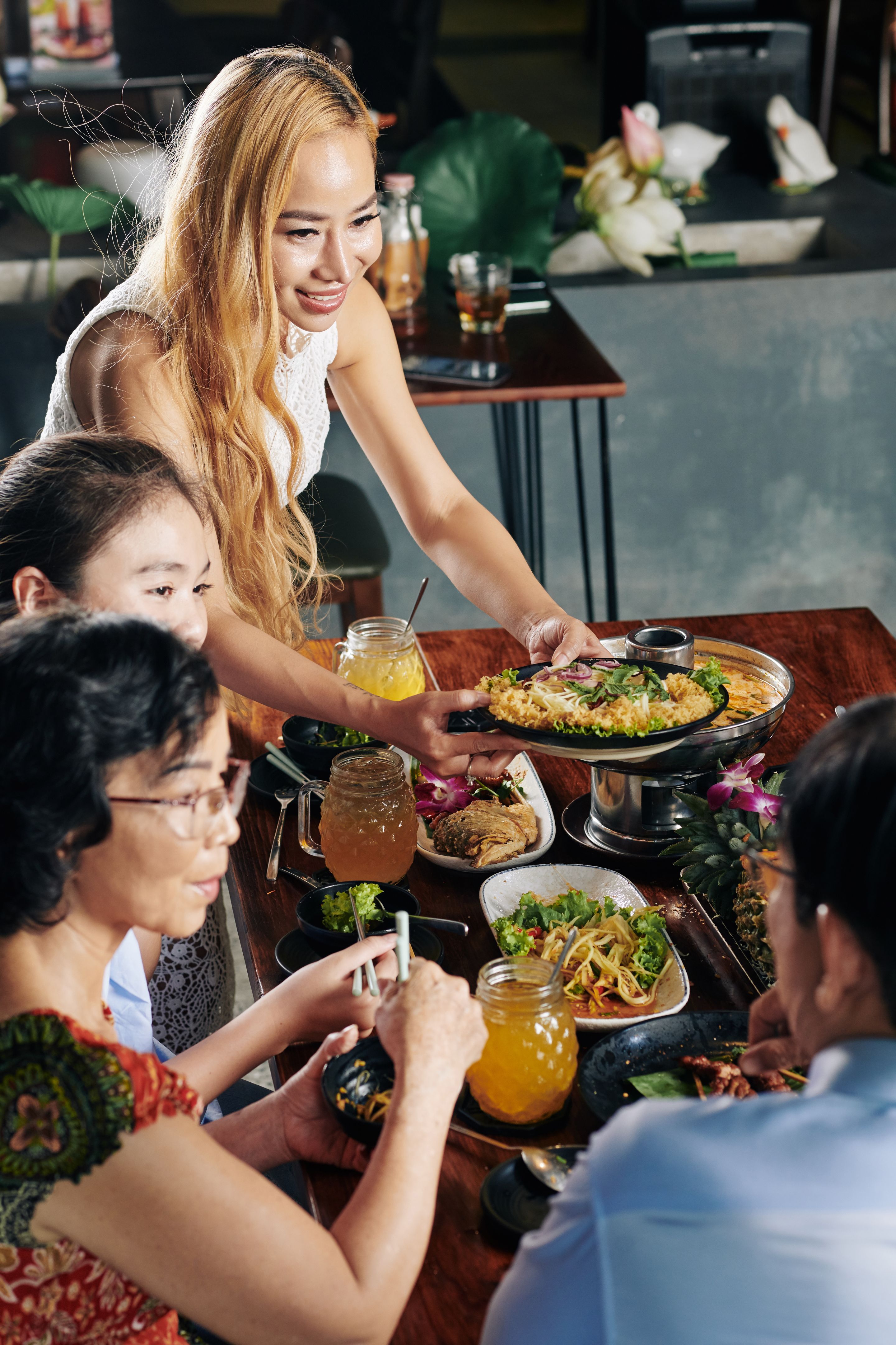 Beautiful woman serving tasty dish Beautiful woman serving tasty dish