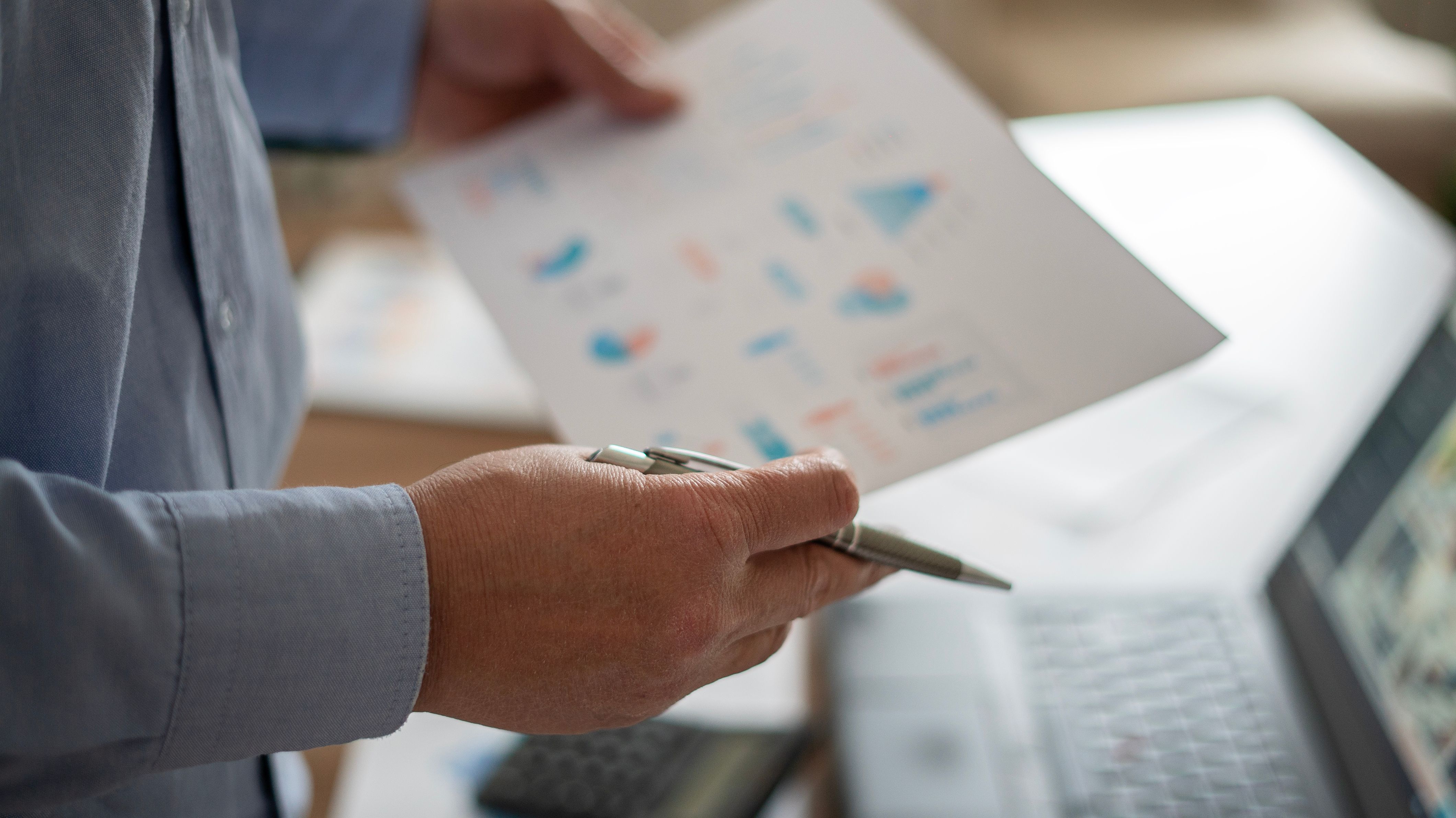 Adult businessman reviewing financial reports at home