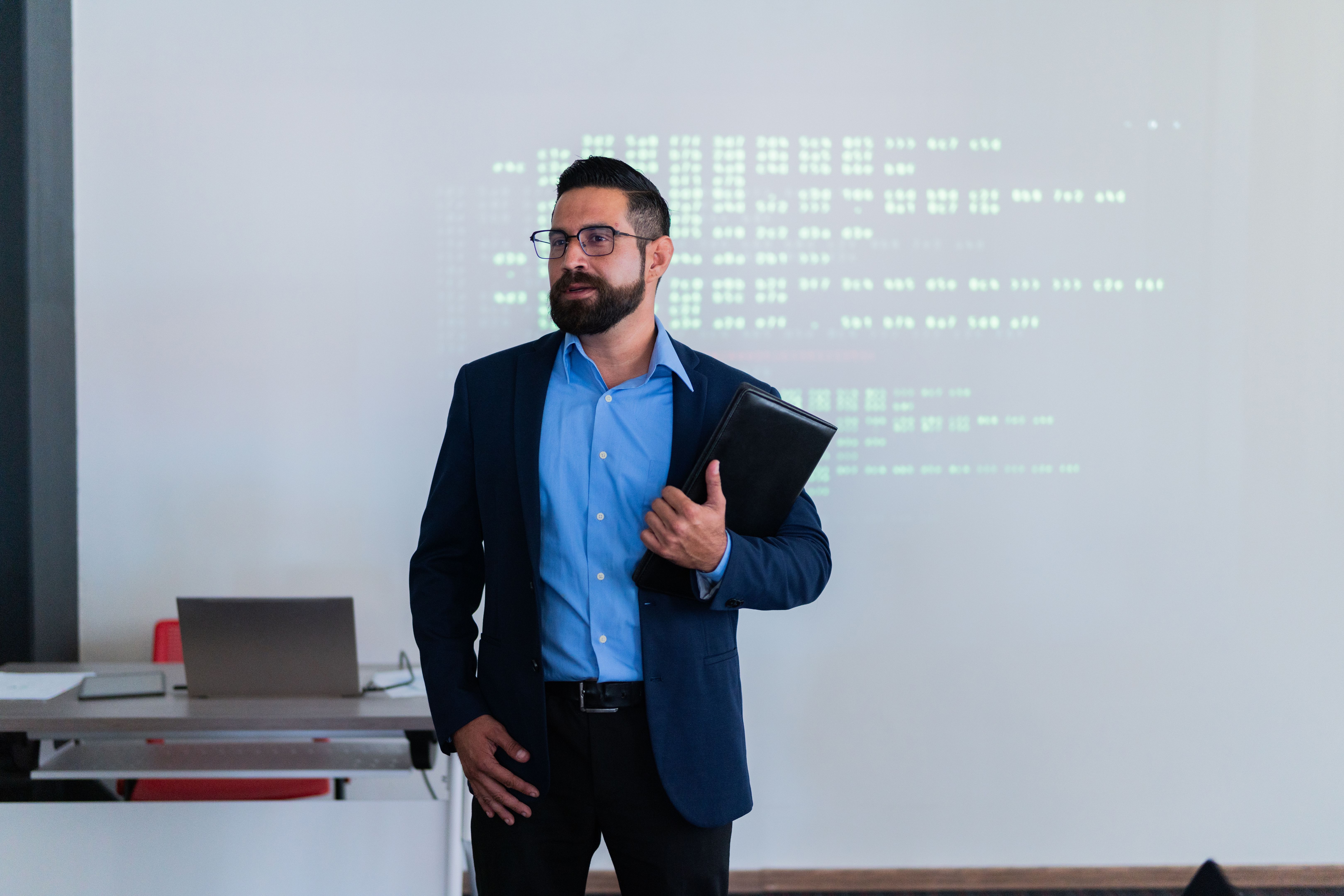 Mid adult man doing a presentation at meeting office