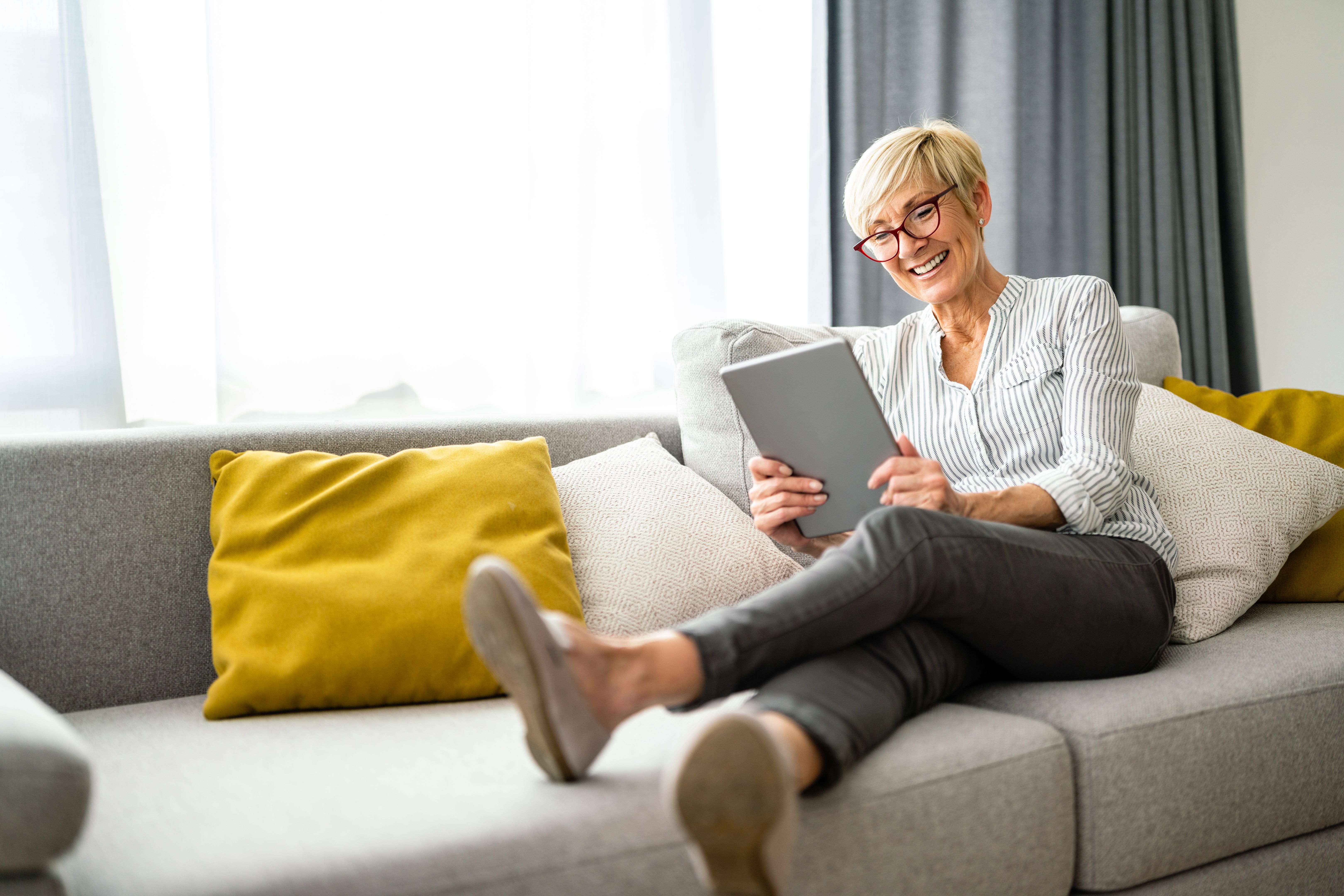 happy senior using tablet