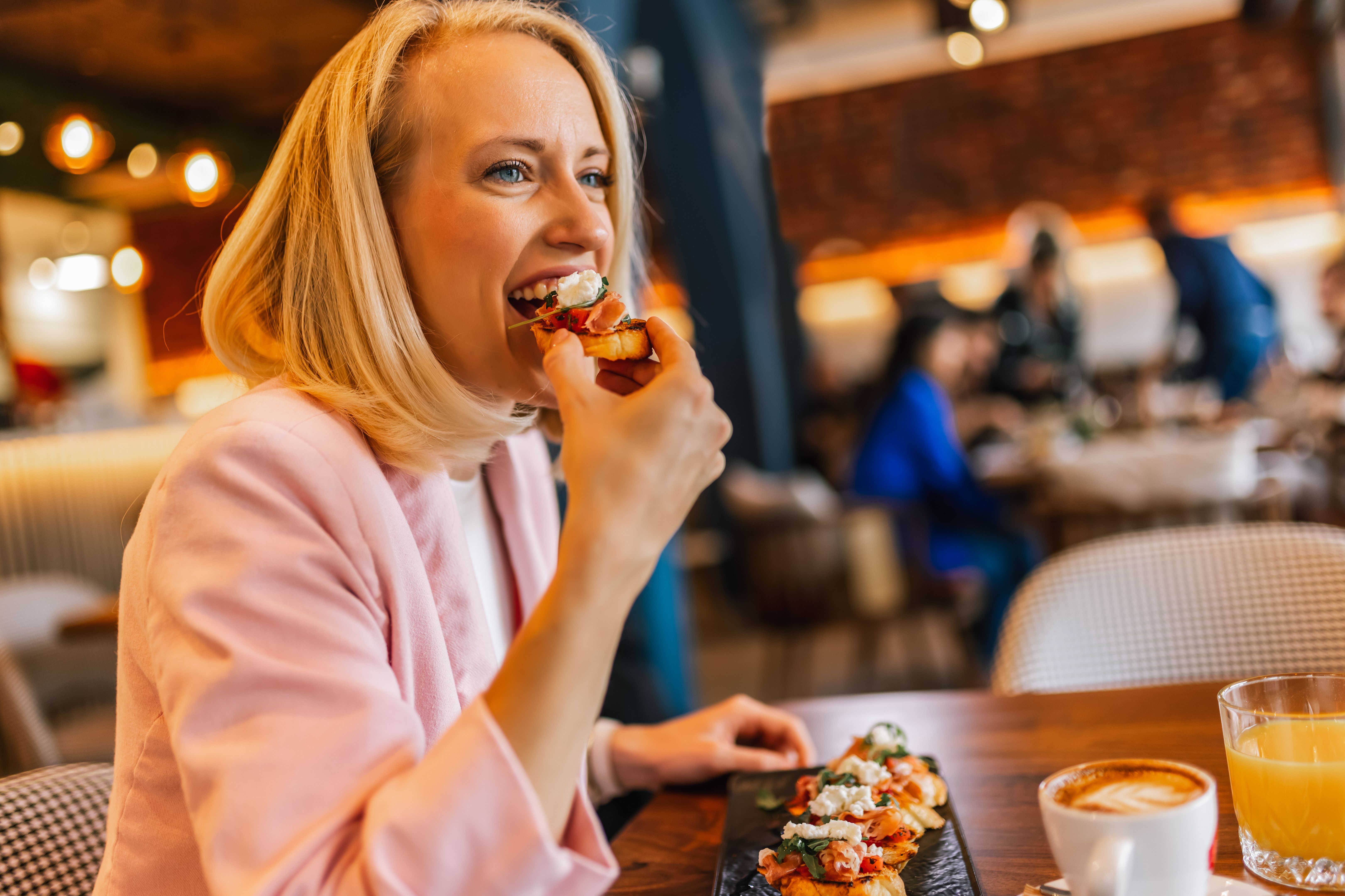 Friends gathered in a restaurant to eat delicious food, talk, drink and hang out. Friends gathered in a restaurant to eat delicious food, talk, drink and hang out.