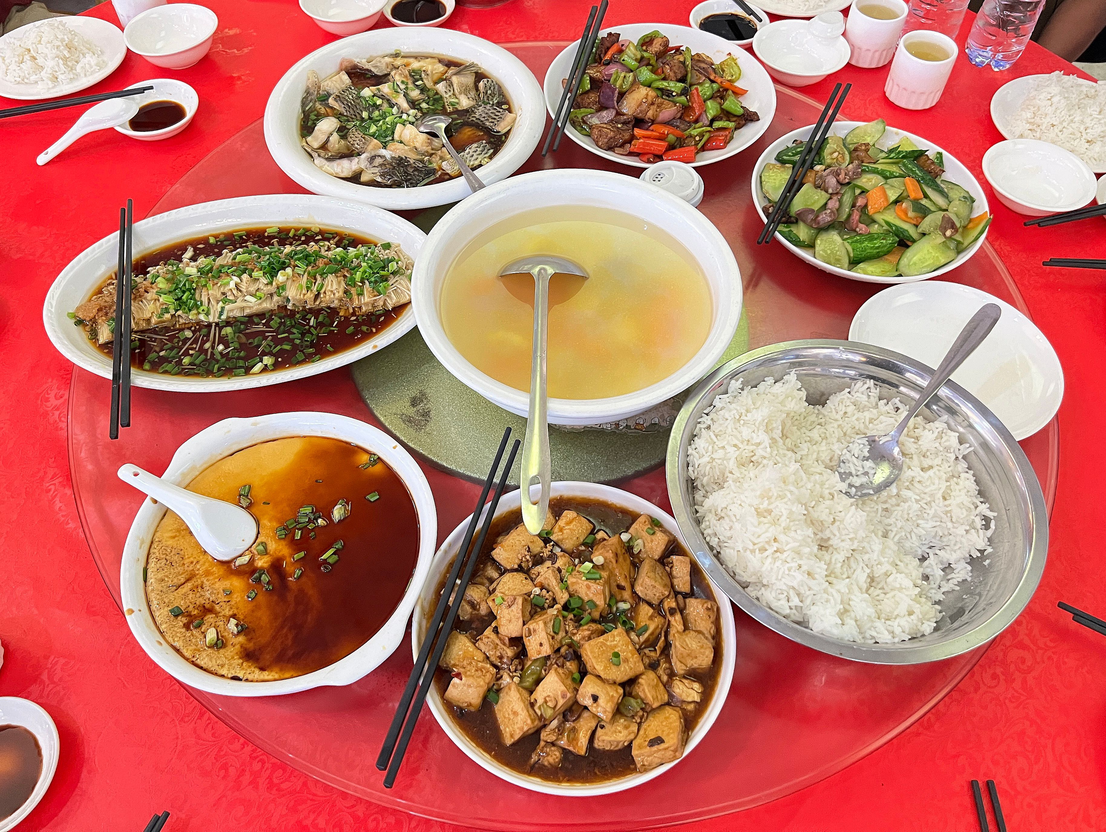 A traditional Chinese banquet with rice, soup, vegetables and seafood