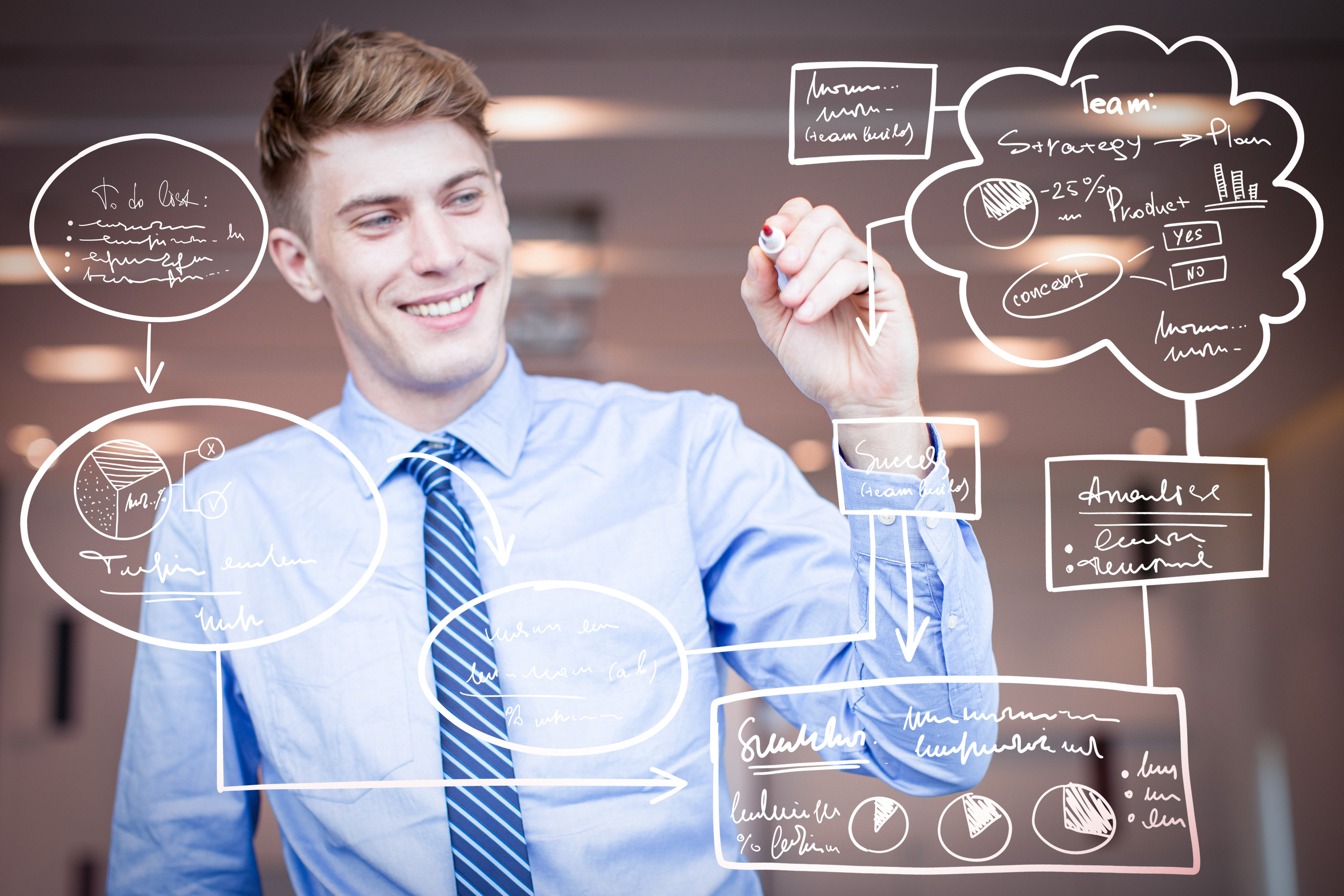 A smiling businessman uses a stylus to draw a colorful flowchart on a transparent digital board.