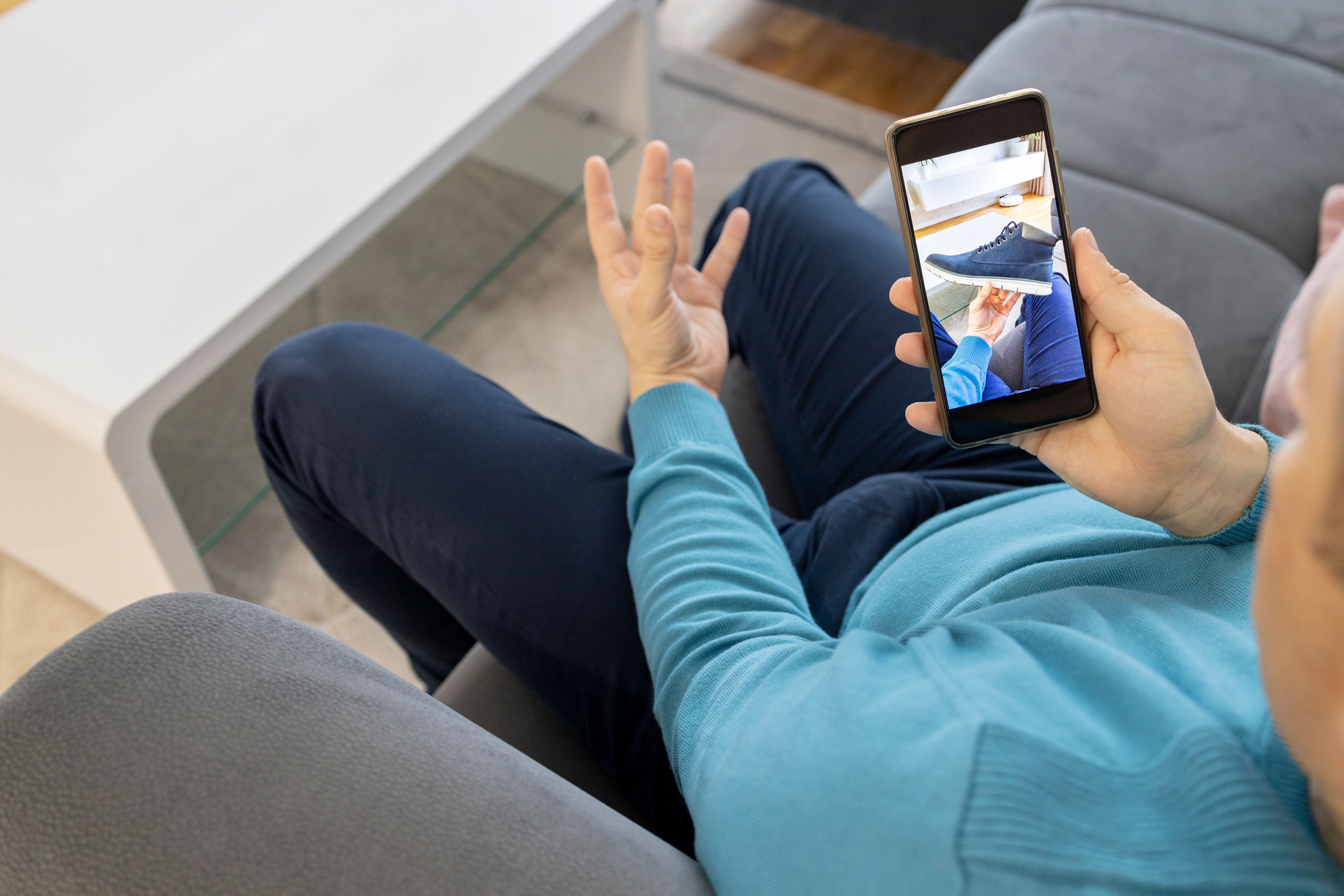 A man holding virtual shoe A man holding virtual shoe