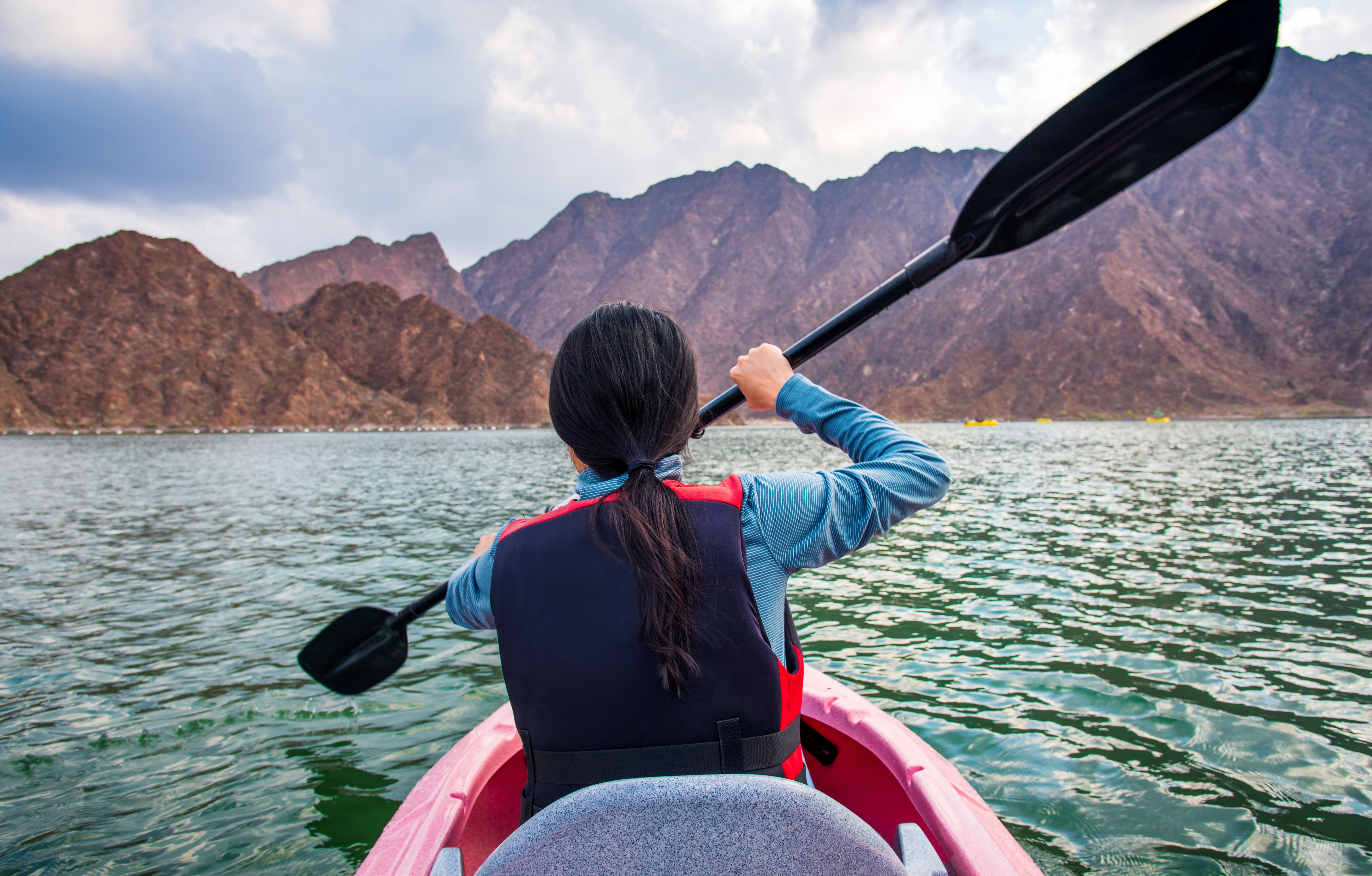 Woman kayaking in a lake closeup