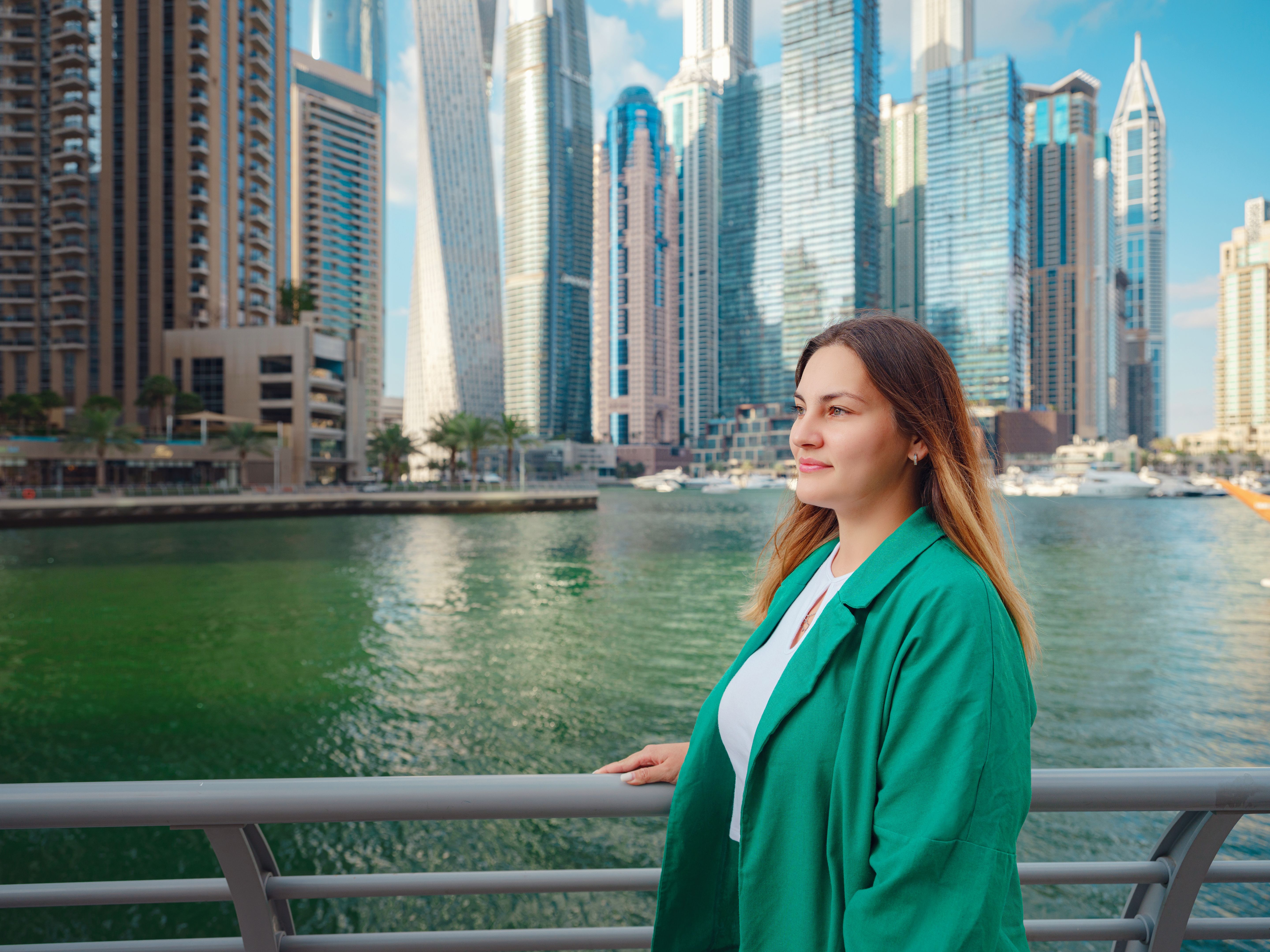 woman walks streets of Dubai, Dubai Marina
