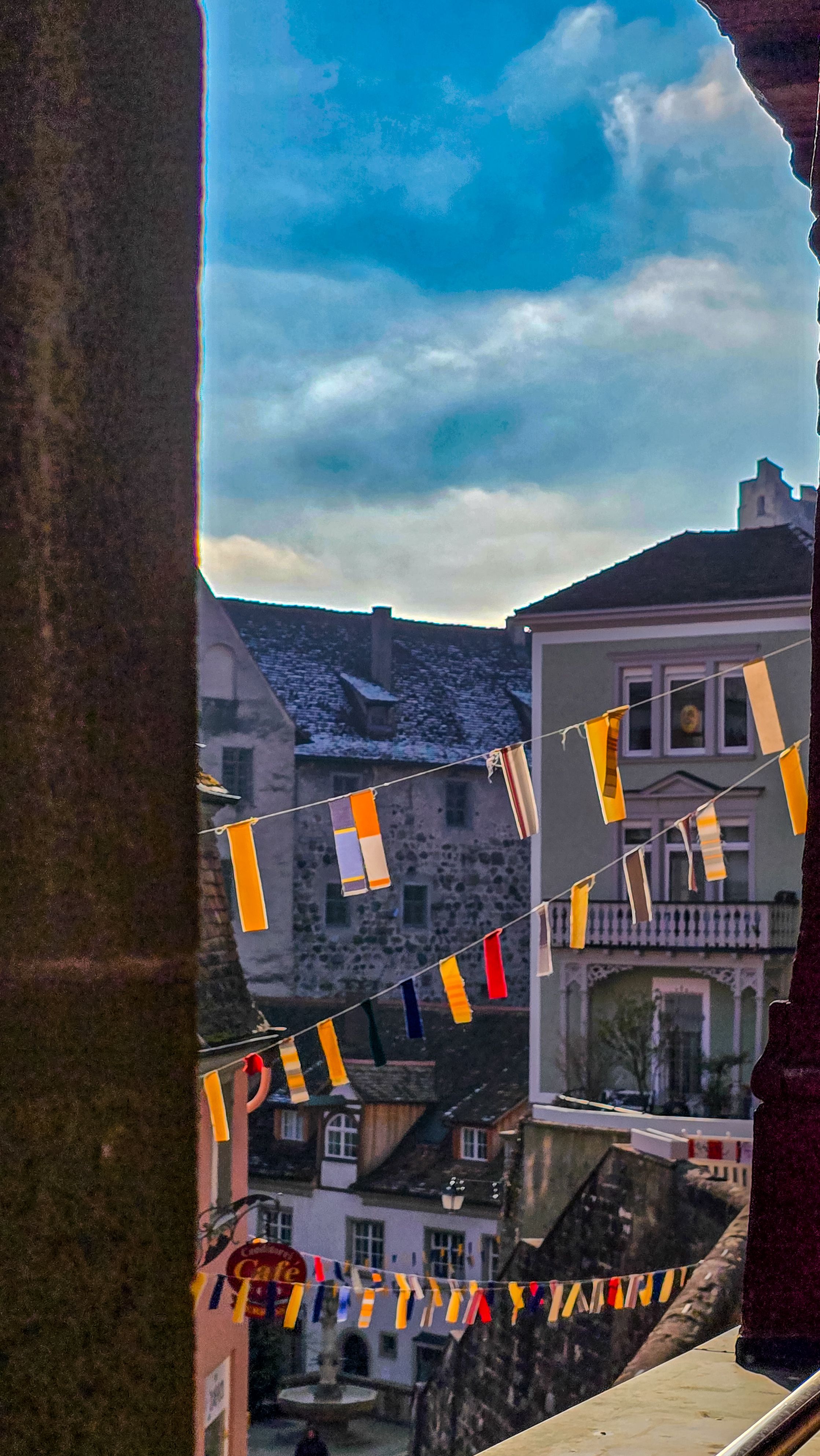 View of a charming medieval town during a traditional annual carnival. Fastnacht. In the foreground - traditional garlands of multicolored flags. February 18, 2025. Meersburg, Baden-Wurttenberg, Germany.