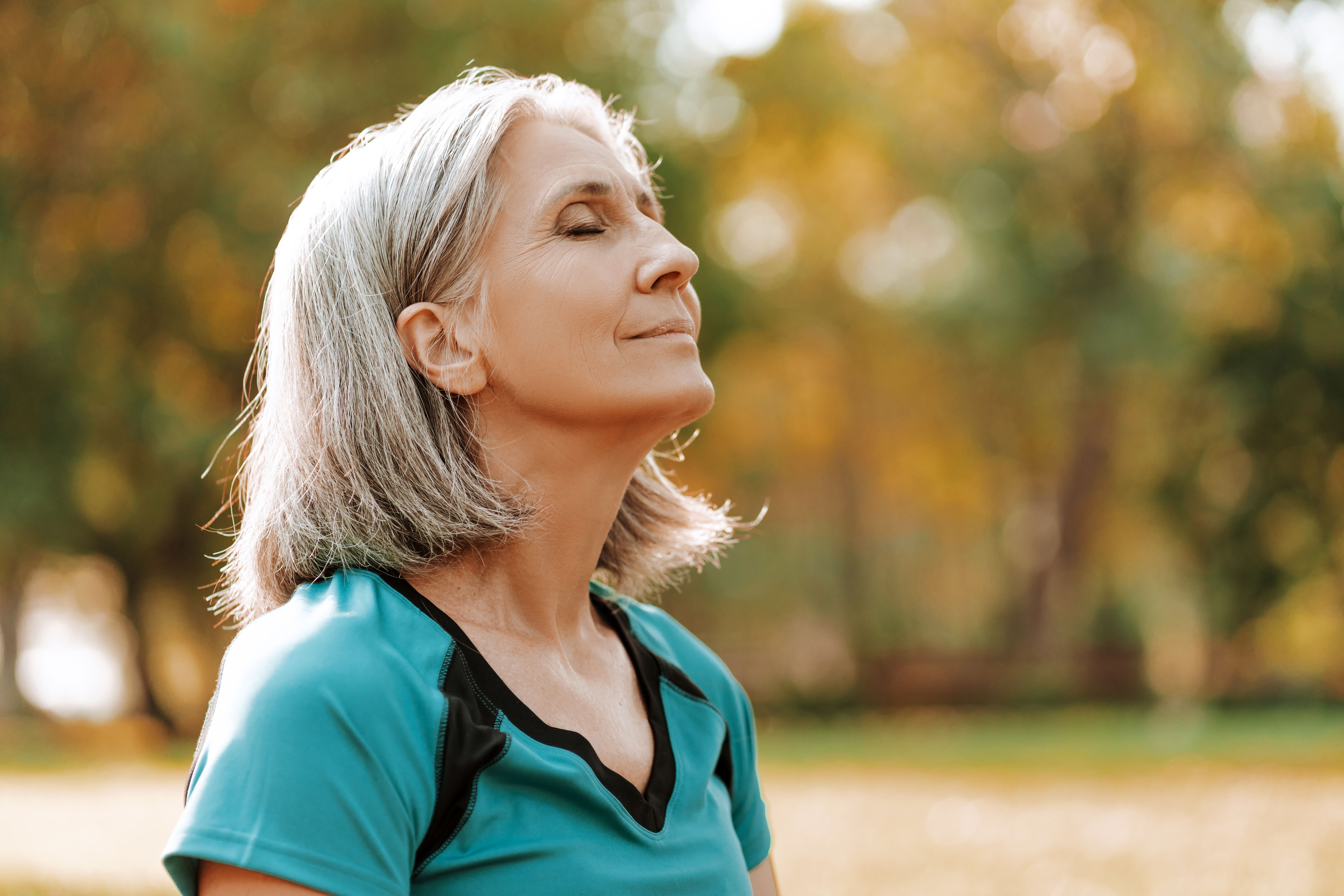 Beautiful senior woman breathing fresh air in park, closeup outdoors, copy space Beautiful senior woman breathing fresh air in park, closeup outdoors, copy space