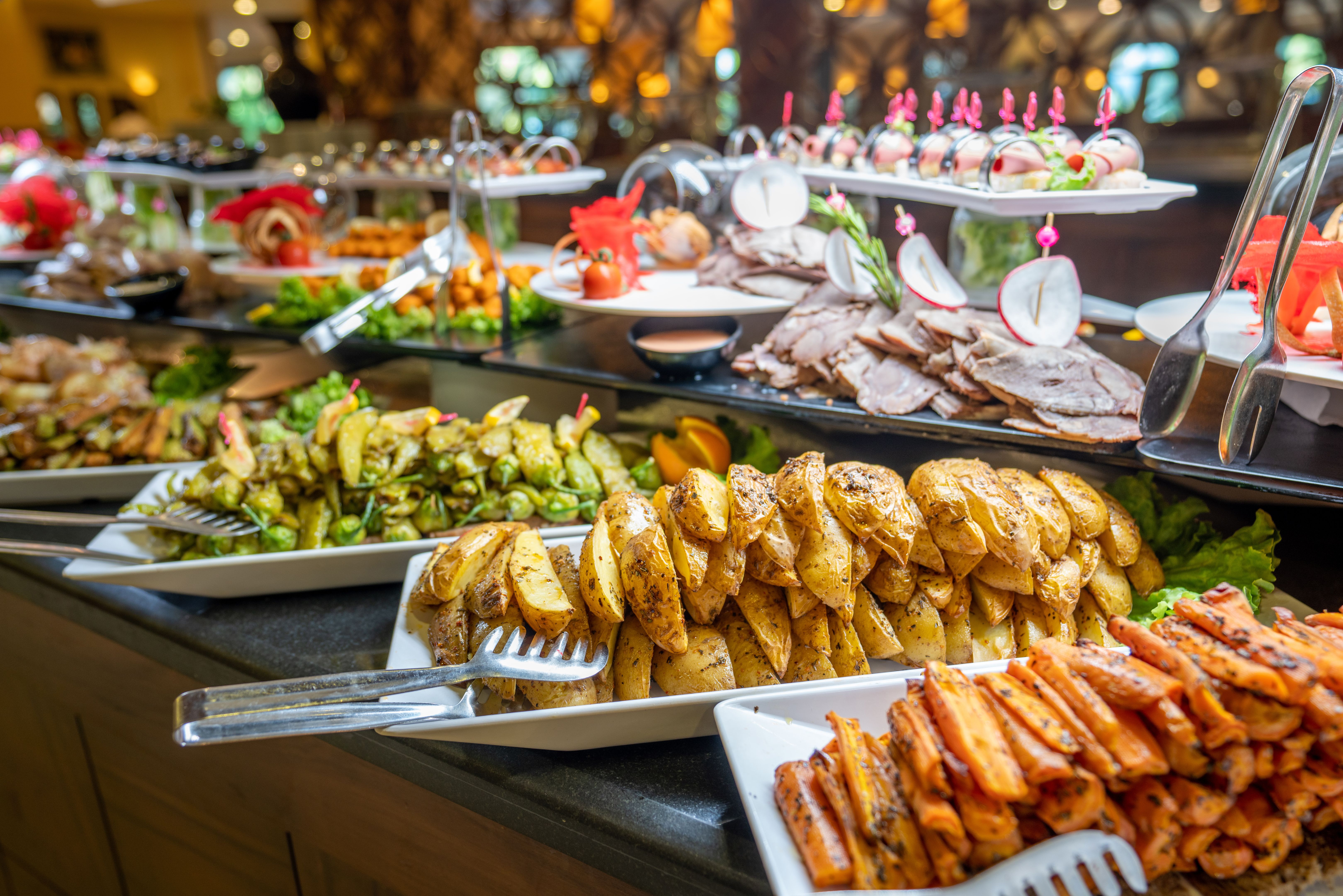 Close up of foods with plates in buffet of restaurant. Close up of foods with plates in buffet of restaurant.