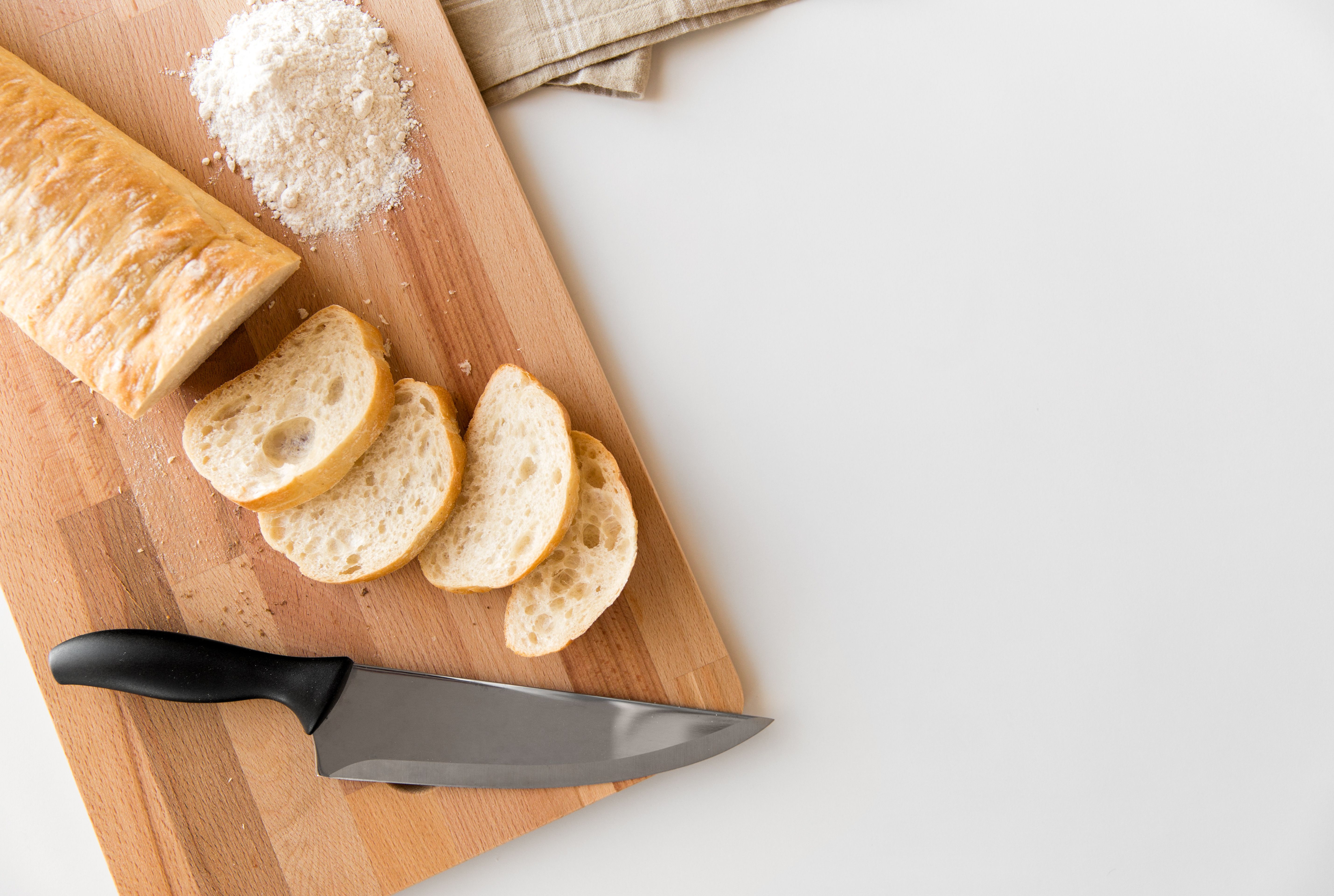 close up of white ciabatta bread on cutting board