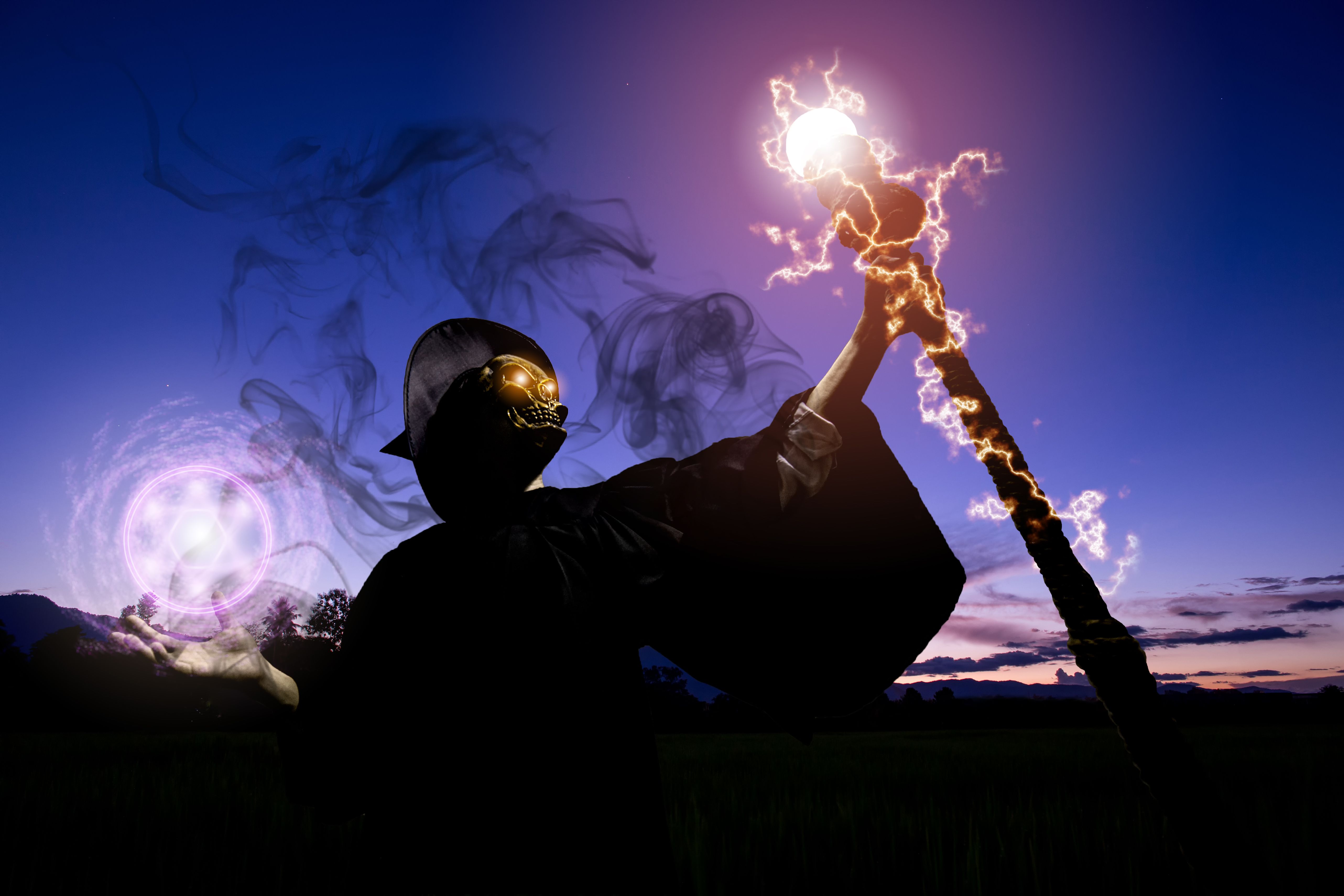 The wizard with the face of the skull is holding a magic rod. He is casting spells to release magical powers. Halloween theme. The wizard with the face of the skull is holding a magic rod. He is casting spells to release magical powers. Halloween theme.