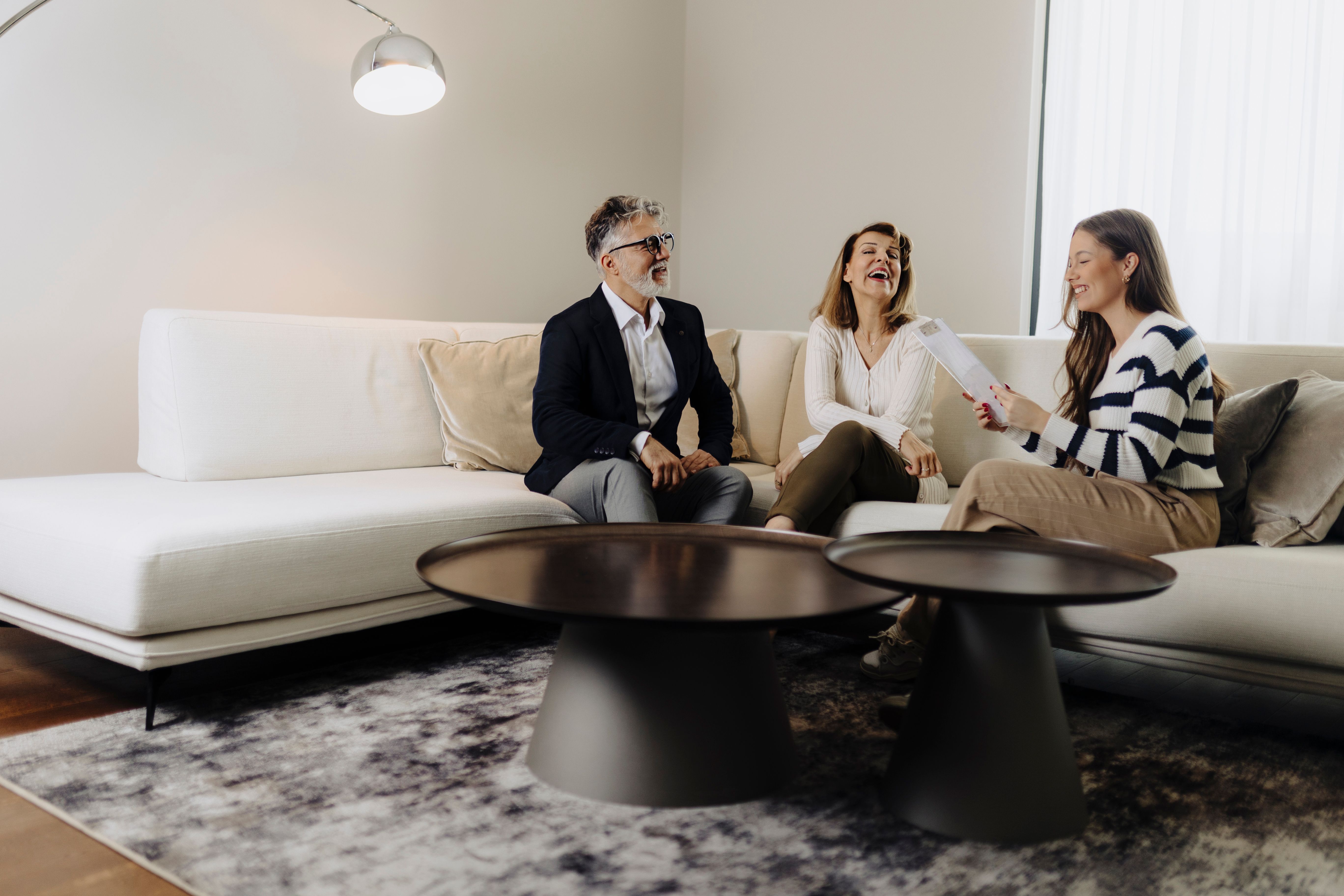 Senior couple talking with female financial or real estate advisor
