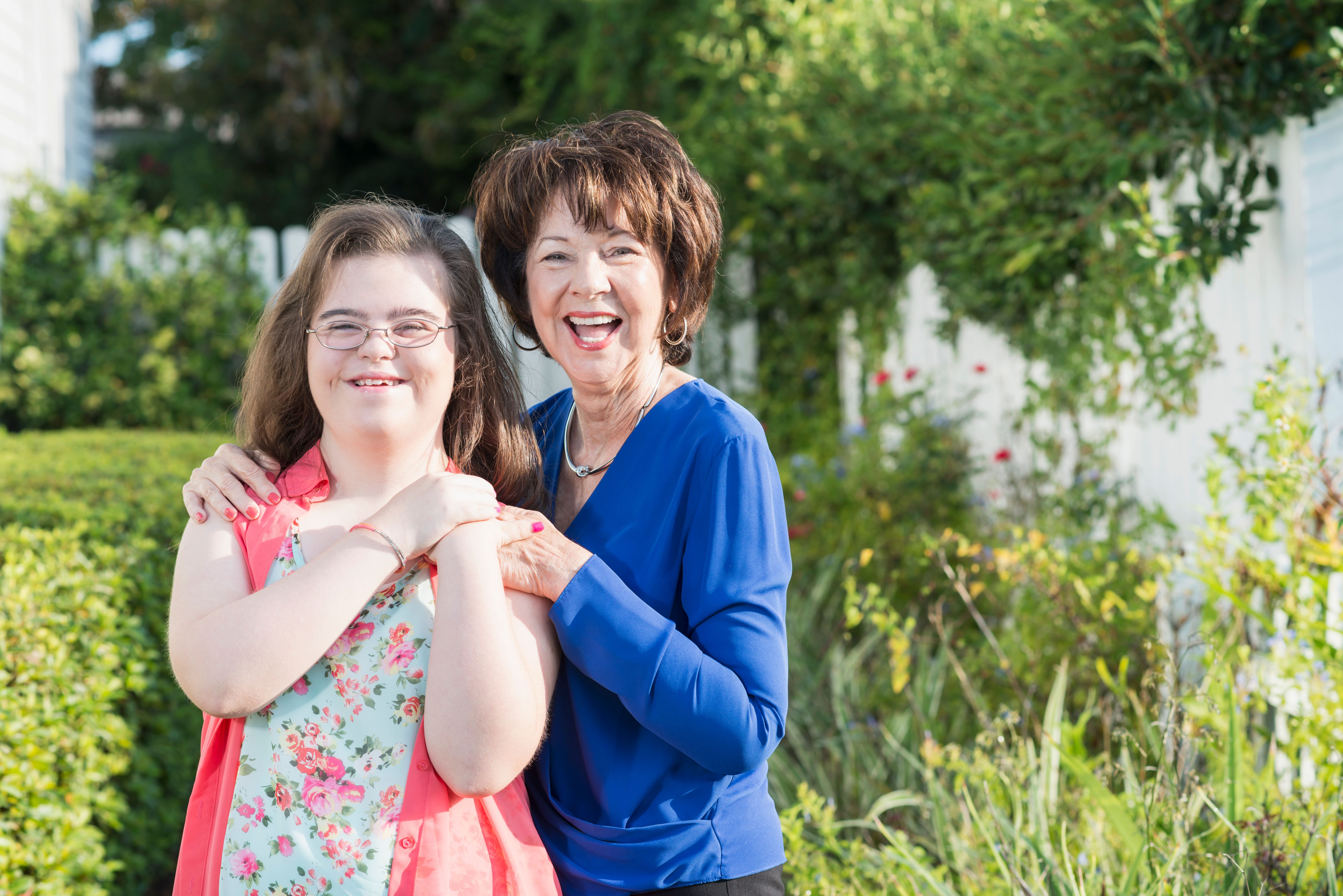 Teenage girl with downs syndrome, grandmother outdoors