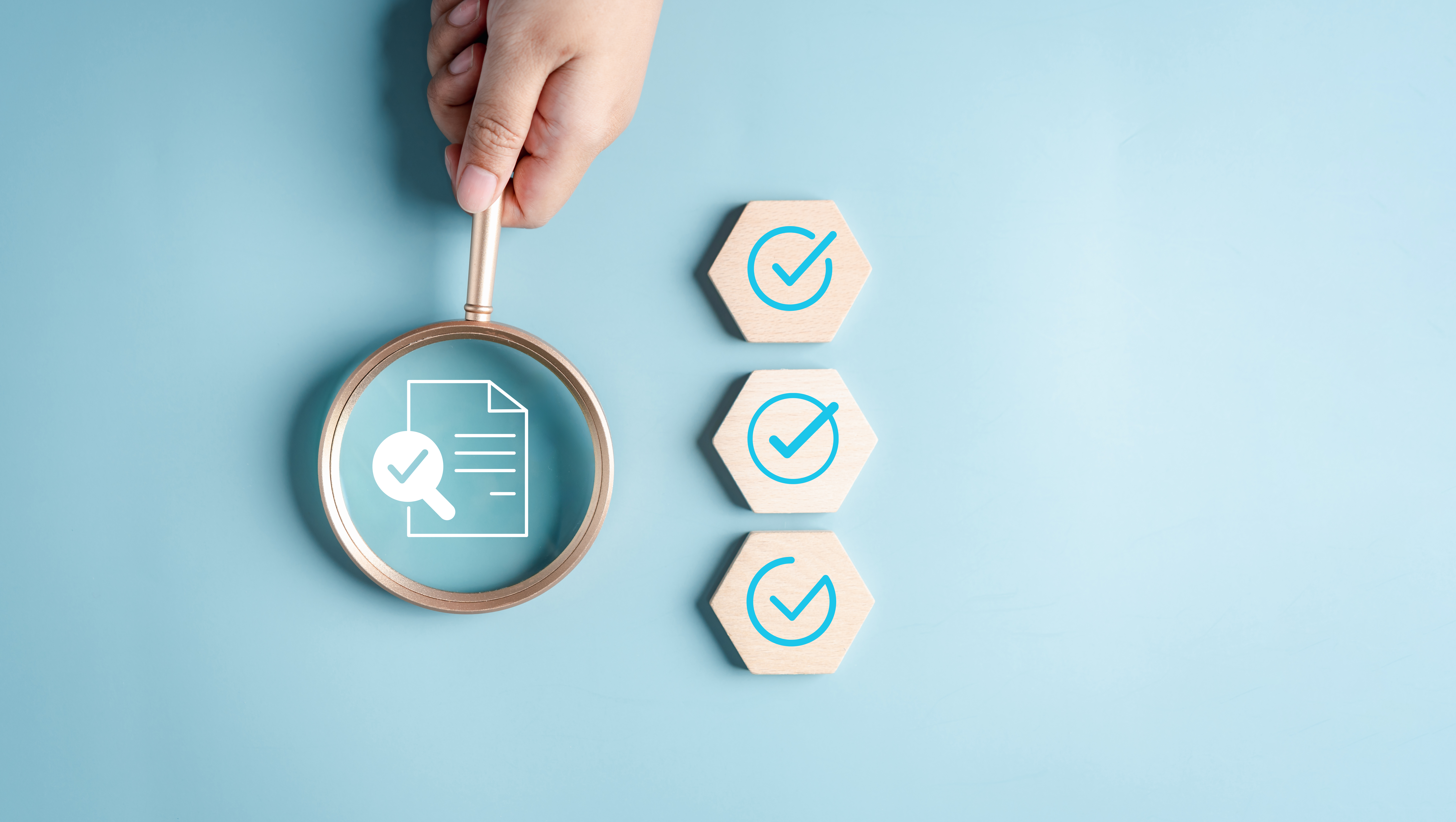 Magnifying glass examining a document icon with a checkmark, alongside three additional checkmarks symbolizing regulatory compliance and internal audit oversight.