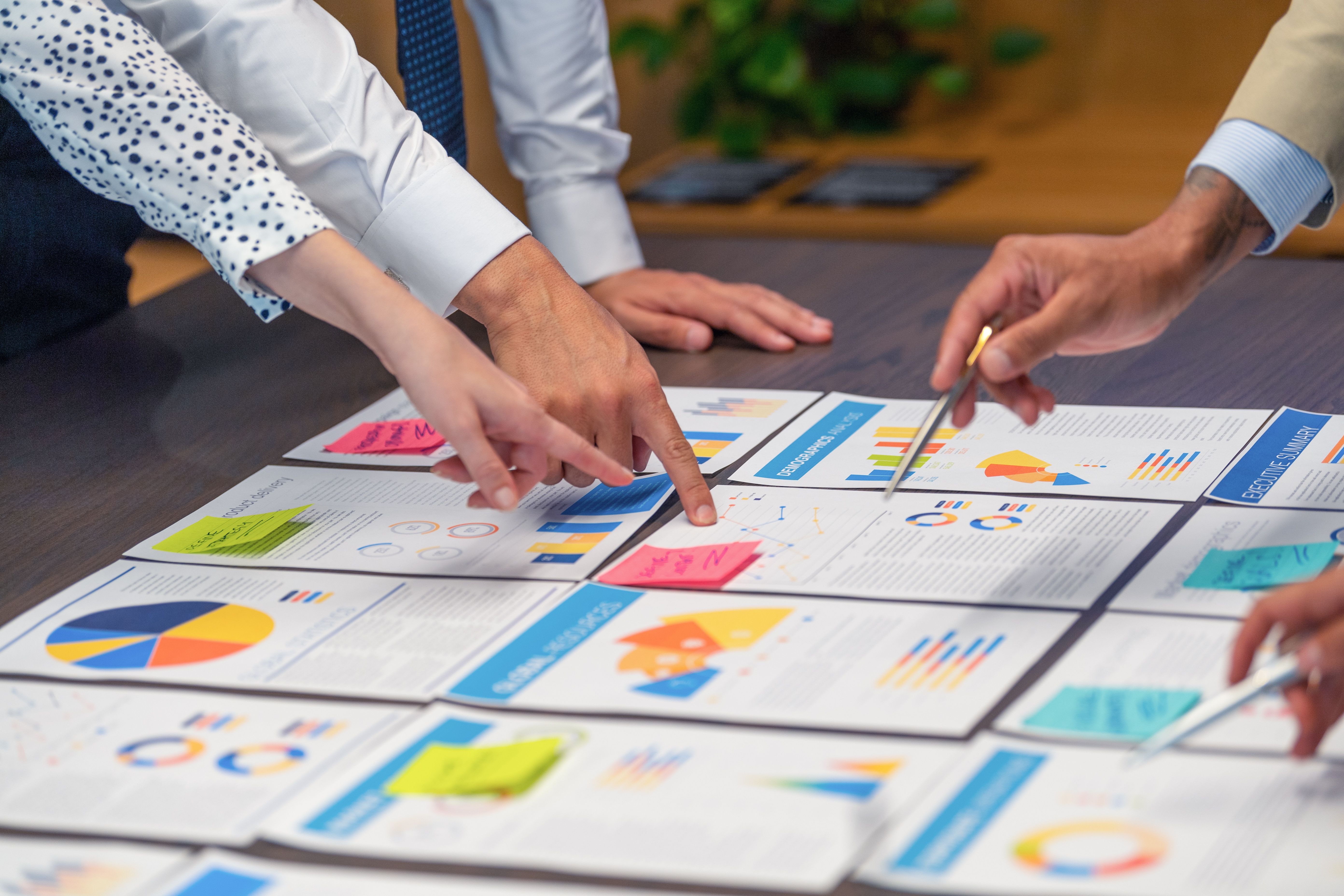 Paperwork and hands on a board room table at a business presentation or seminar. Paperwork and hands on a board room table at a business presentation or seminar.