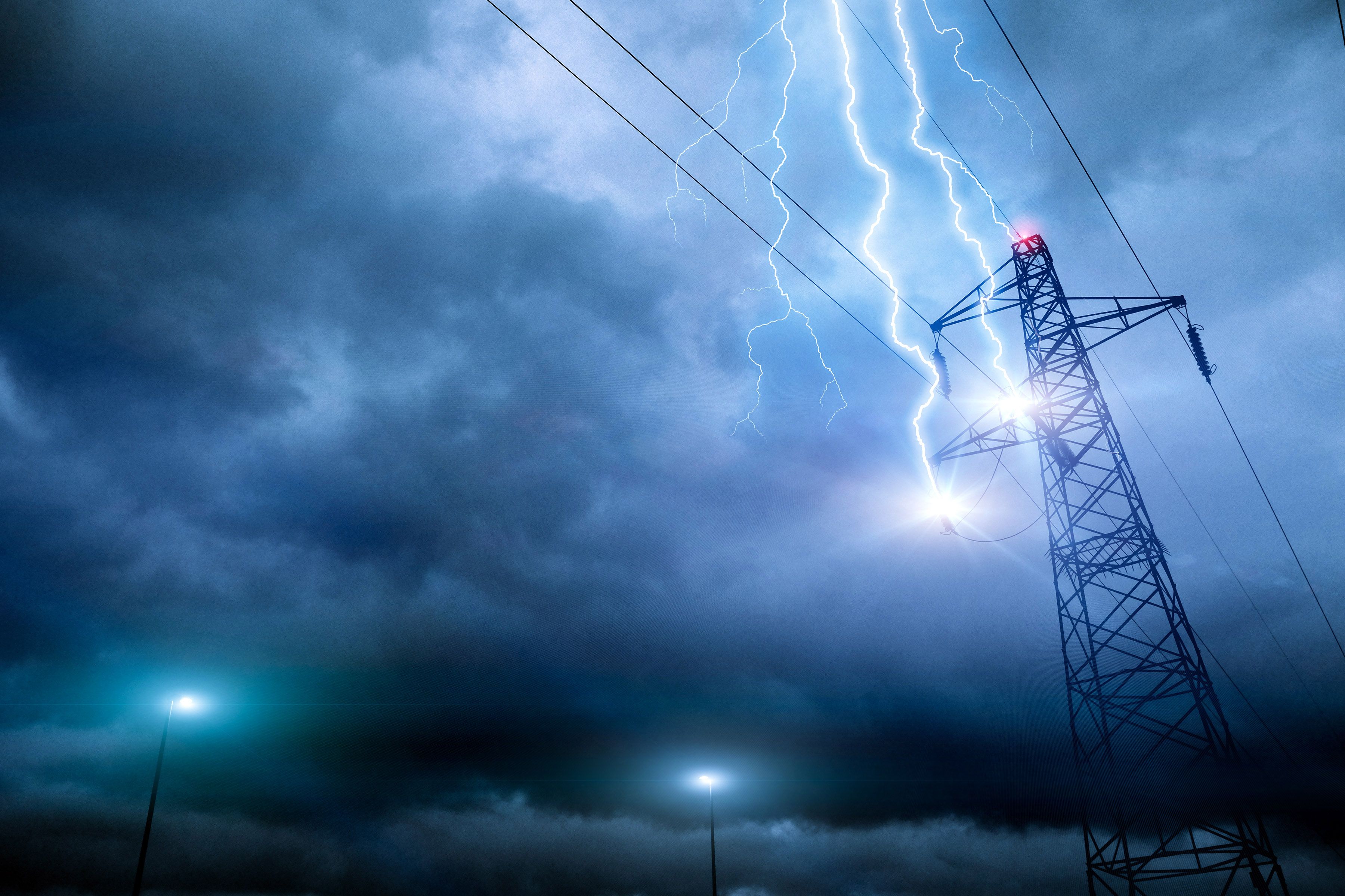Thunderstorm lightning hitting powerline tower