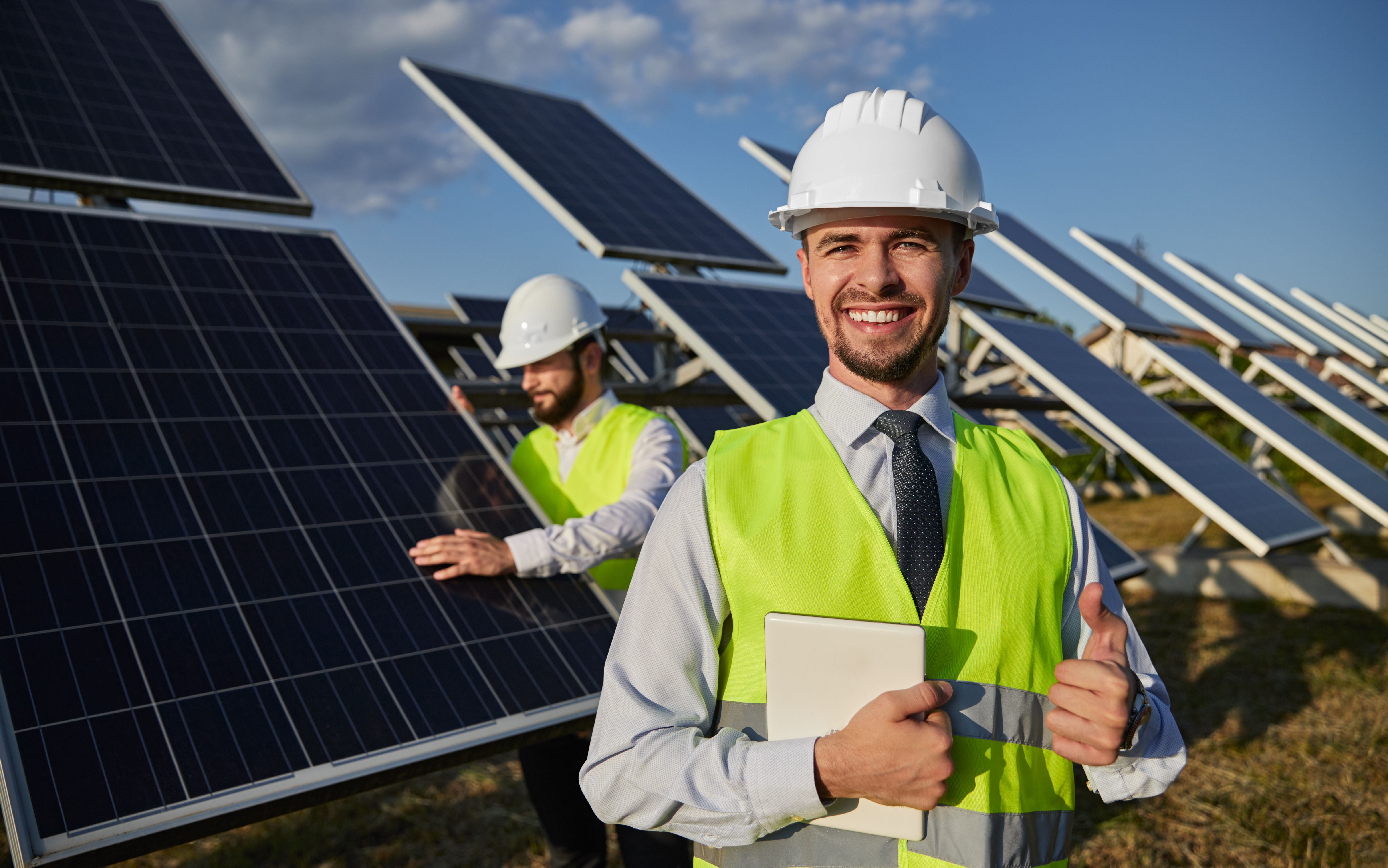 Happy foreman smiling and showing thumb up on solar power station