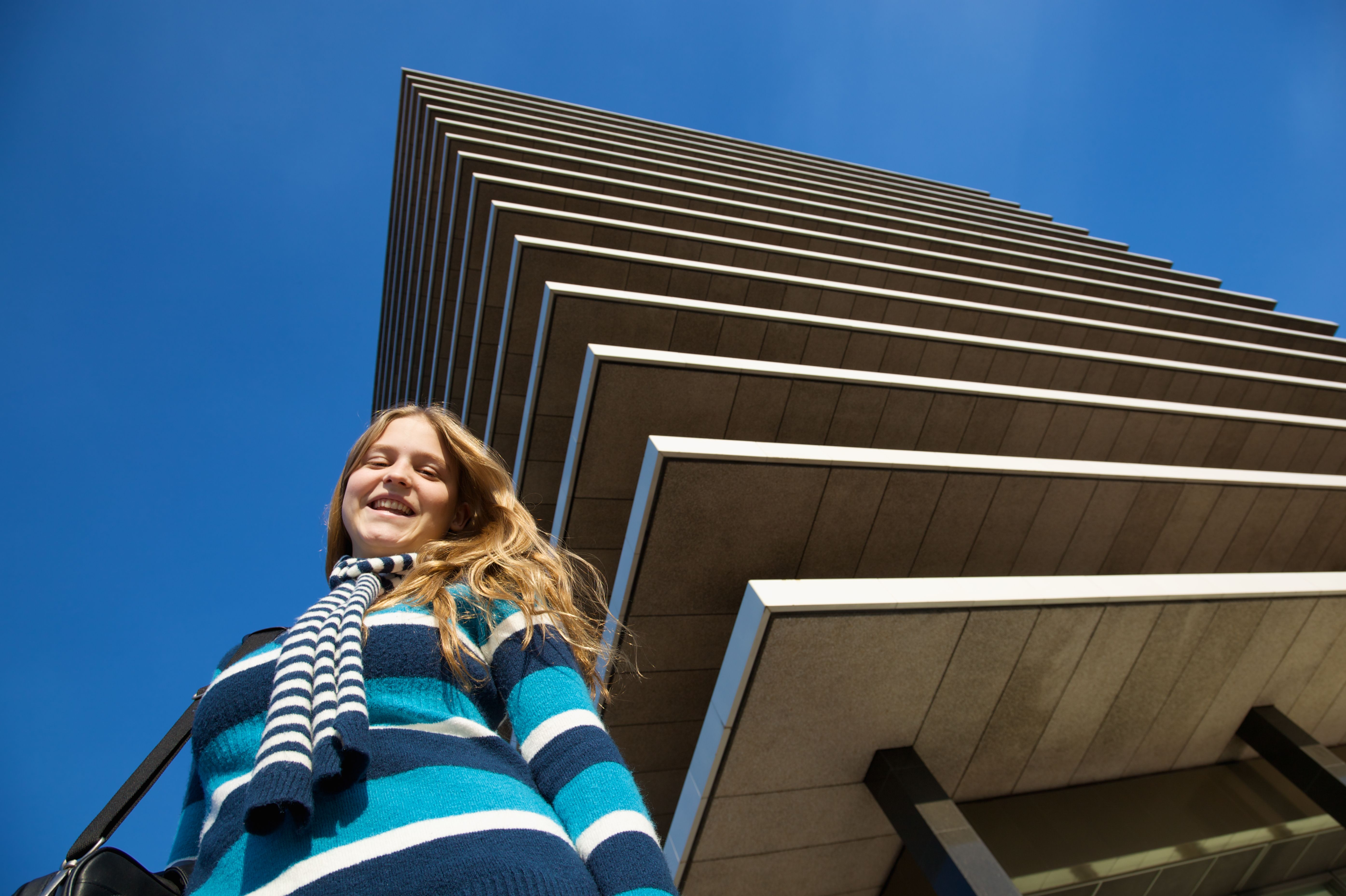 Smiling Teen Girl Outside a Building Smiling Teen Girl Outside a Building