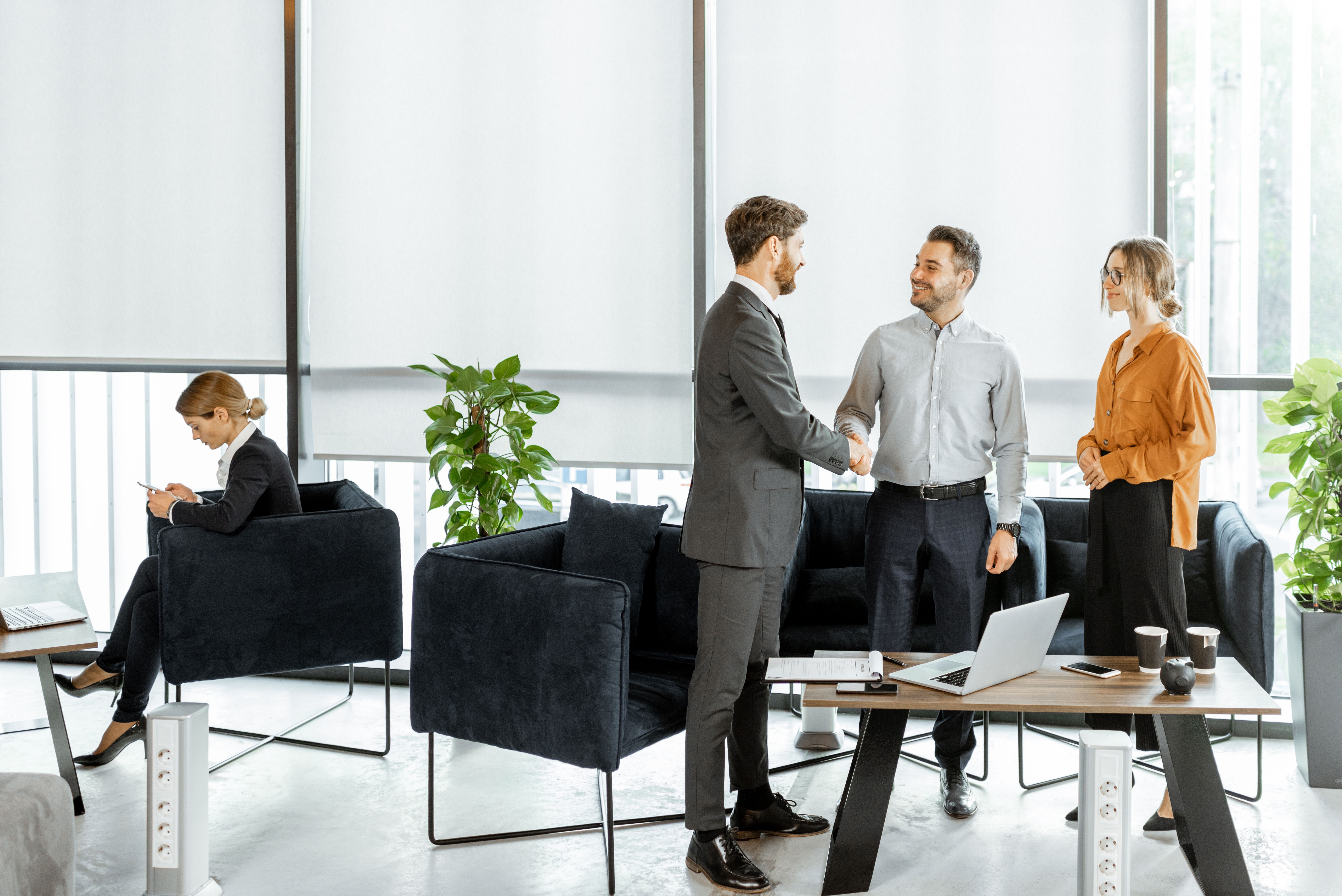 Young couple with financial advisor or agent at the office