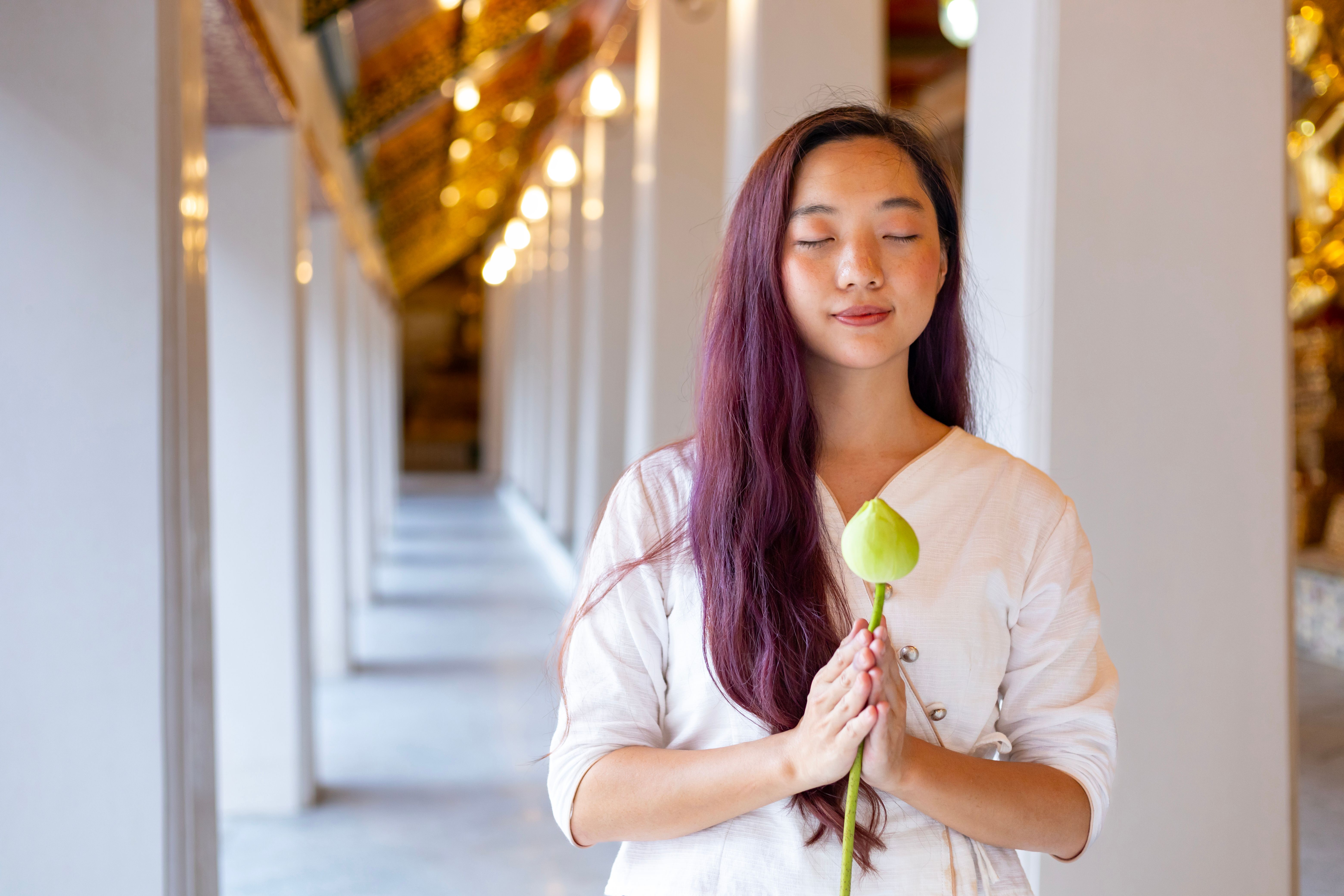 Buddhist asian woman is doing walking meditation around temple for peace and tranquil religion practice