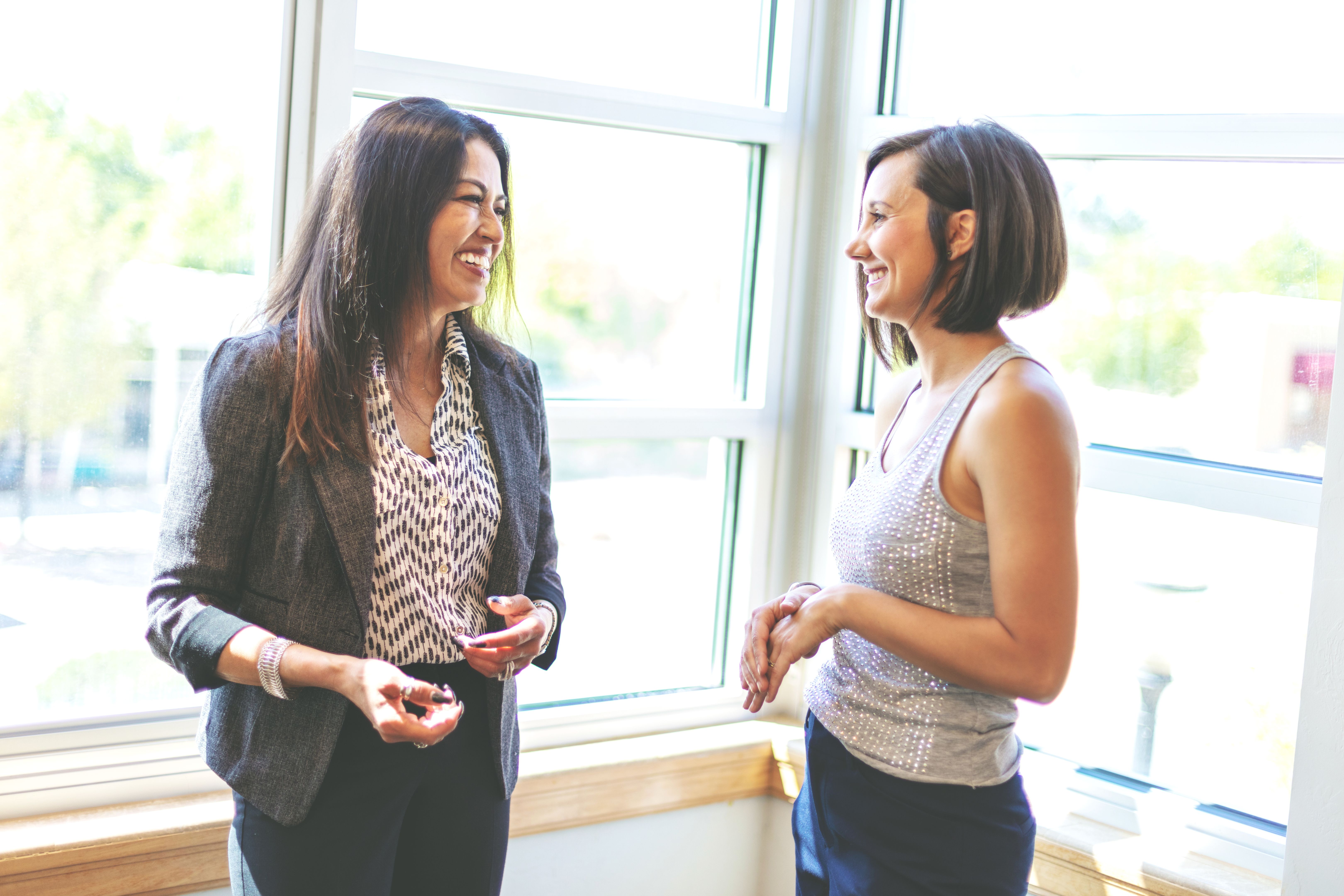 Women Working Together Mature Adult Hispanic Businesswoman Meeting and Conducting Business with Colleagues in Corporate Office Space in Western Colorado