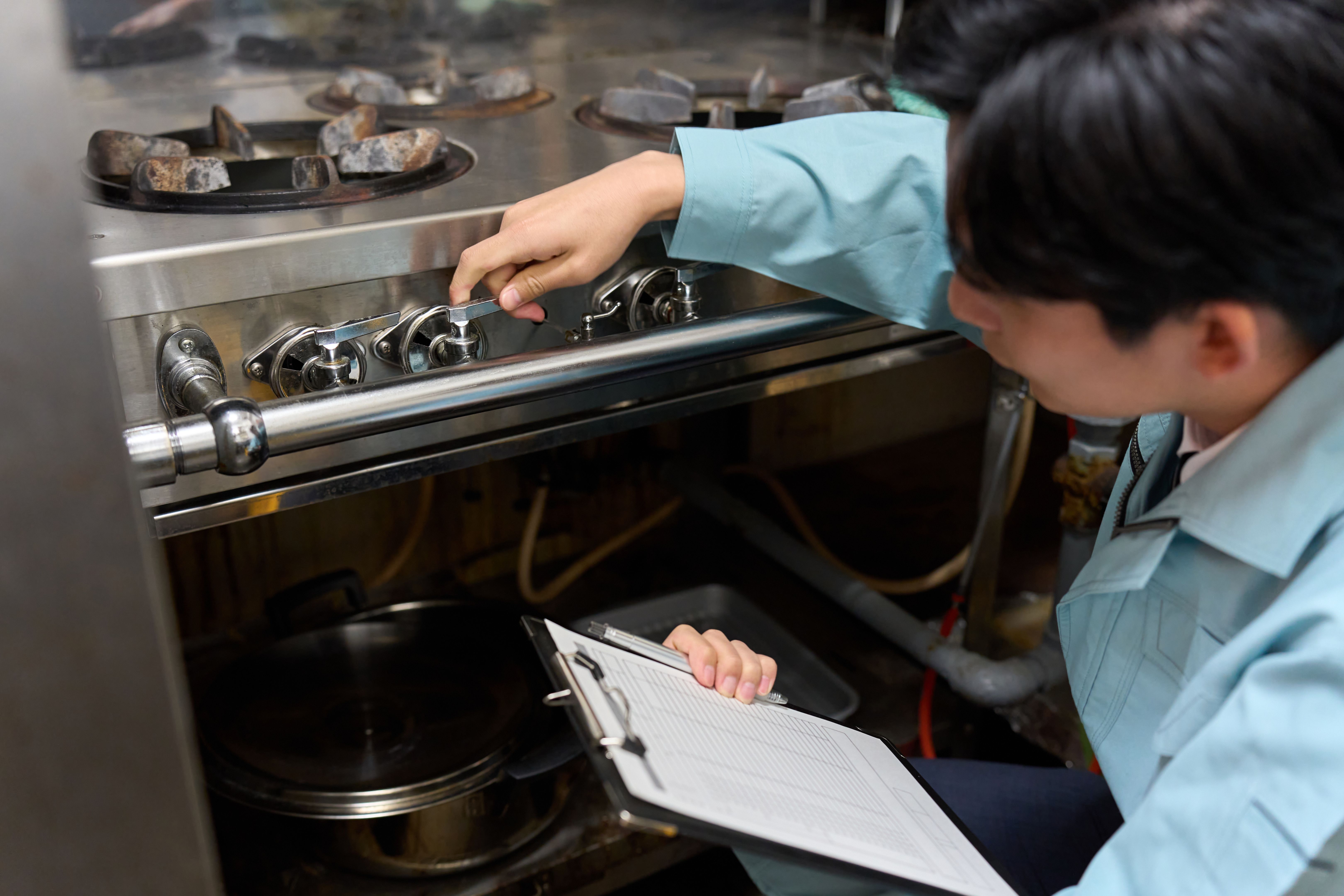 technician inspecting stove